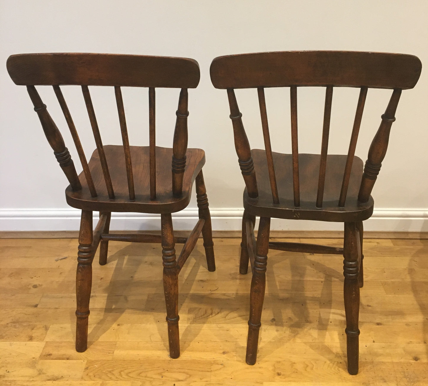 A pair of Victorian spindle-back kitchen chairs.