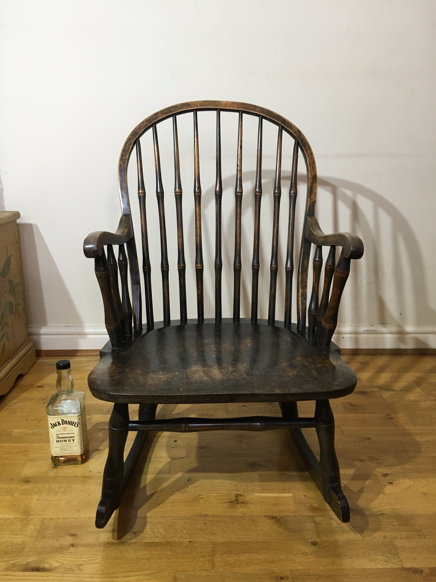 Charming low rocking chair with faux bamboo spindles.