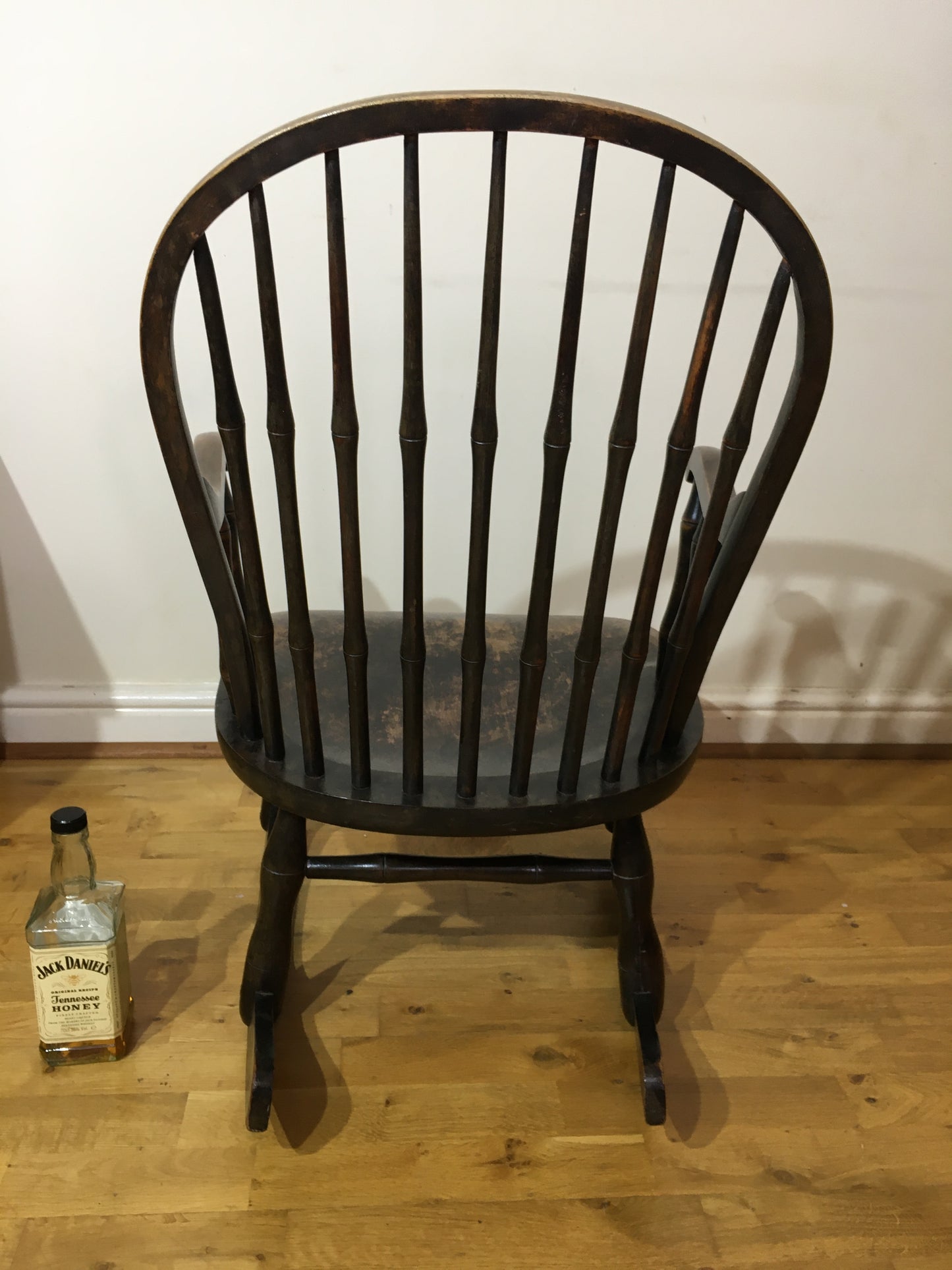 Charming low rocking chair with faux bamboo spindles.