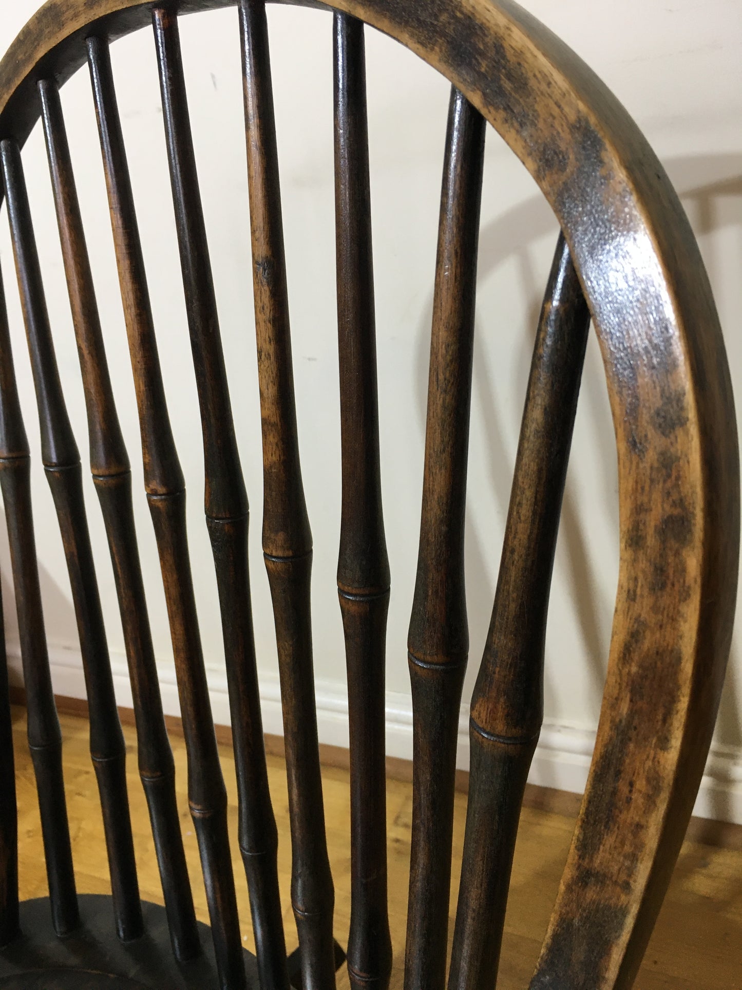 Charming low rocking chair with faux bamboo spindles.