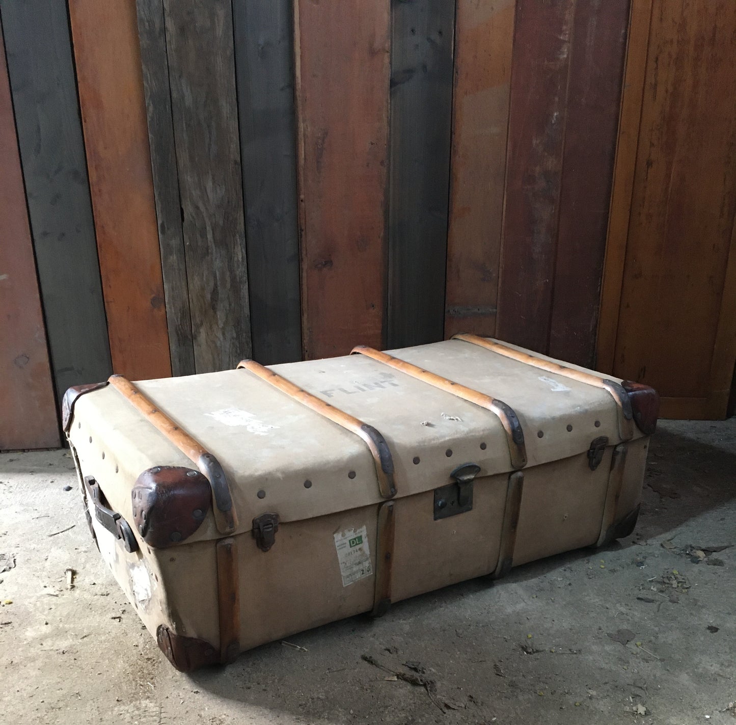 Untouched vintage steamer travel trunk with labels.