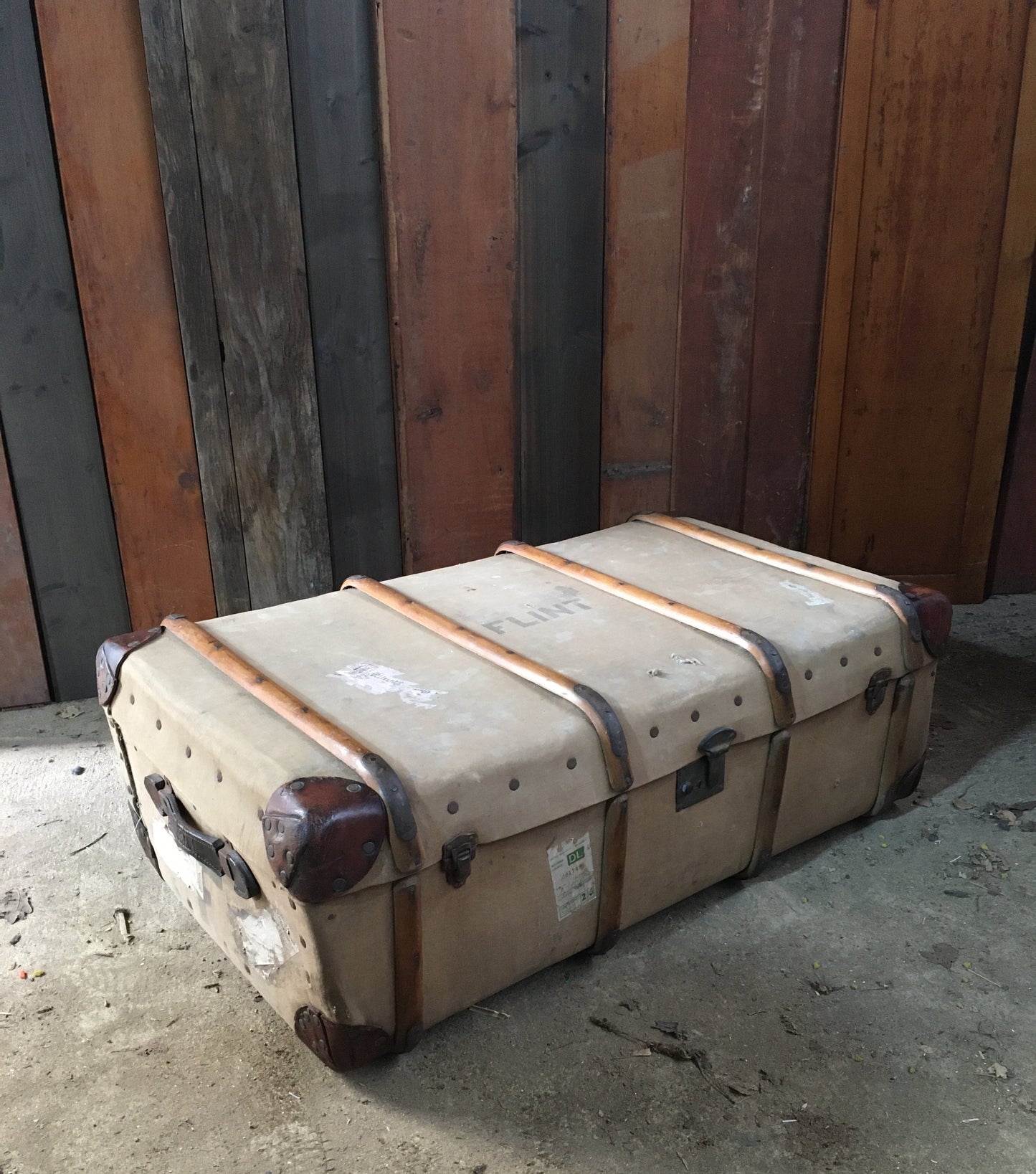 Untouched vintage steamer travel trunk with labels.