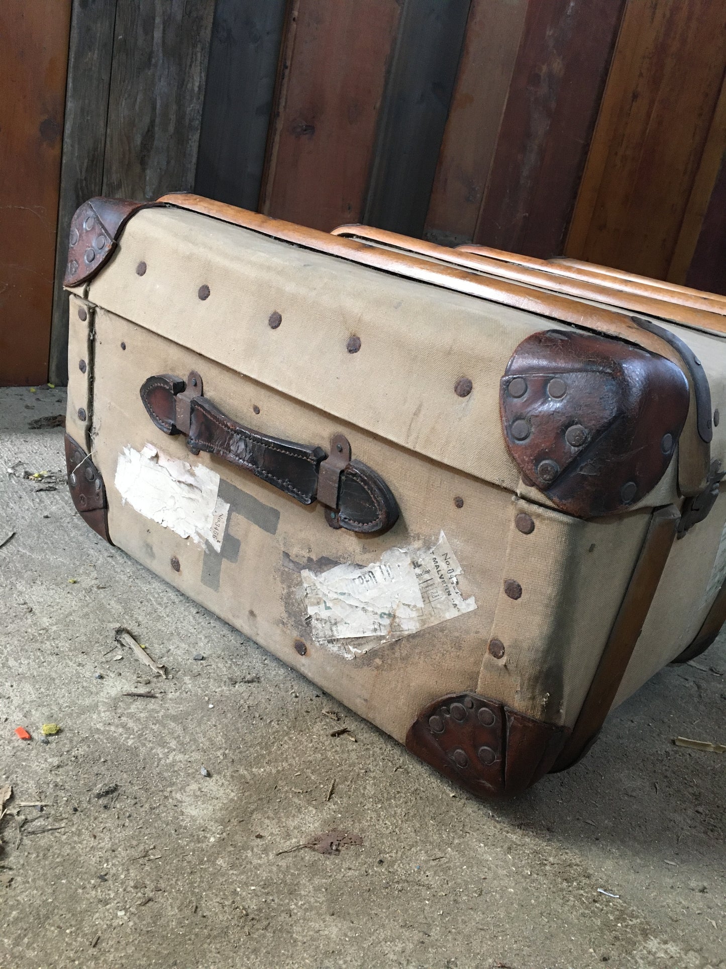 Untouched vintage steamer travel trunk with labels.