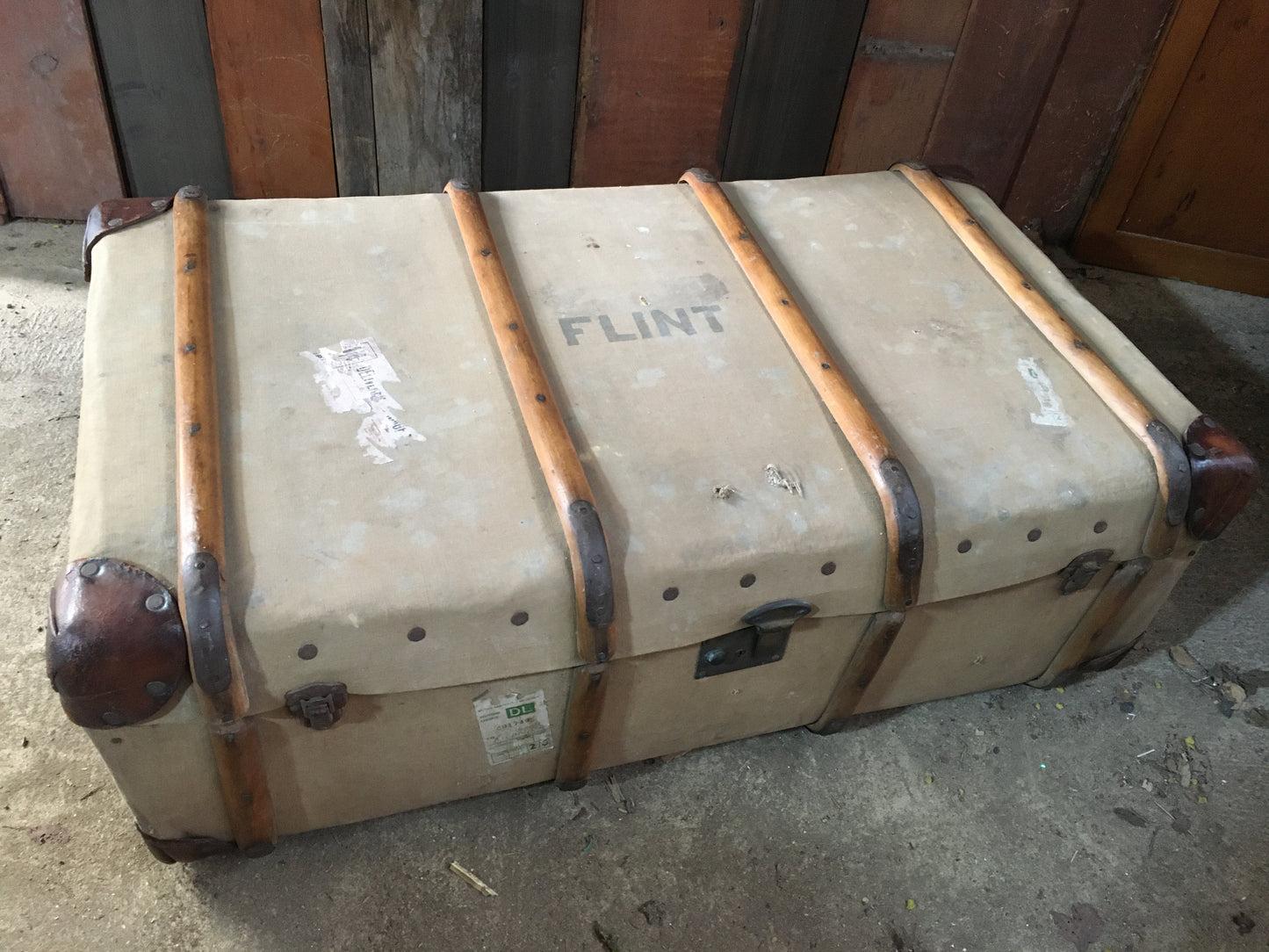 Untouched vintage steamer travel trunk with labels.