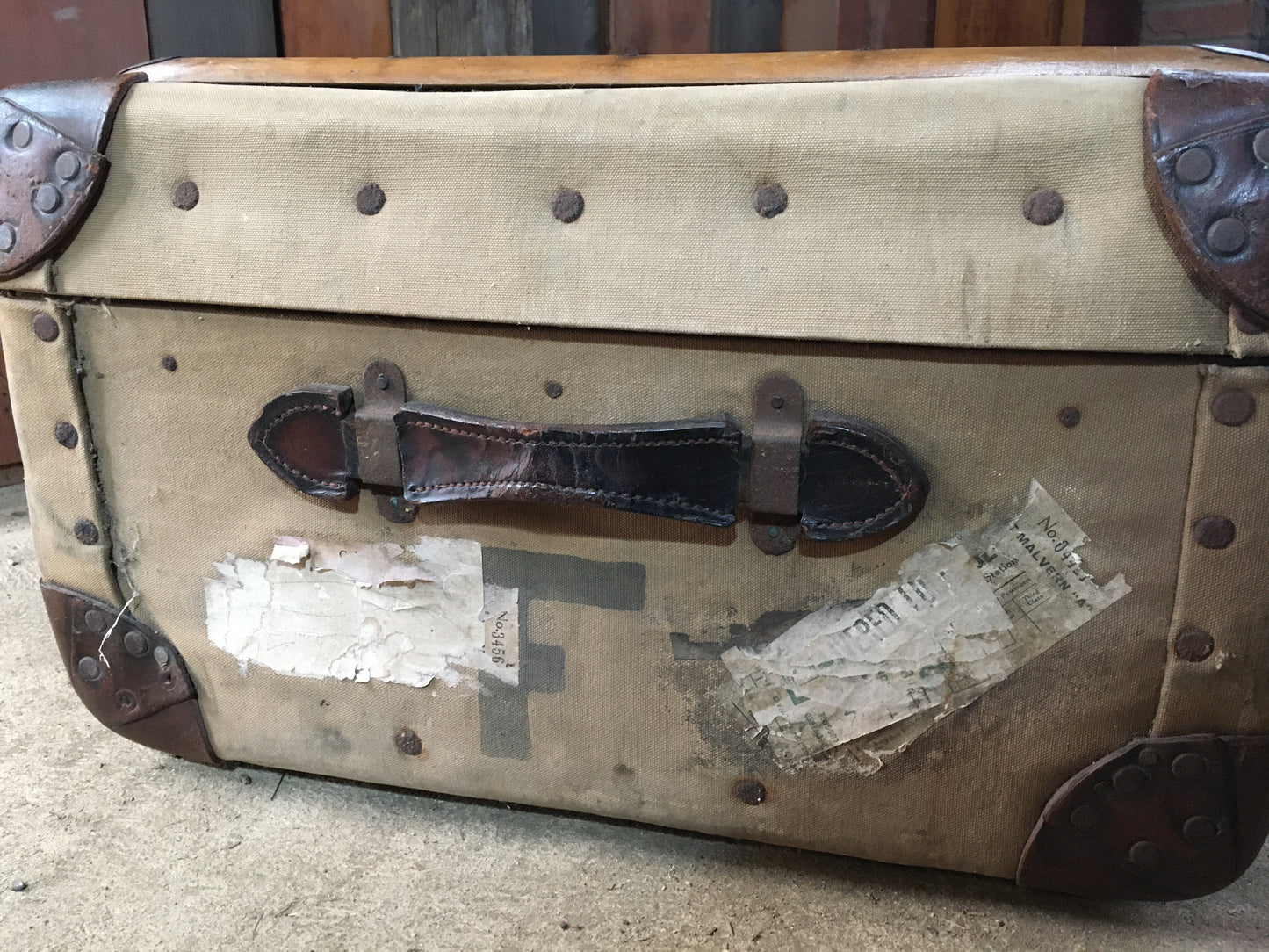 Untouched vintage steamer travel trunk with labels.