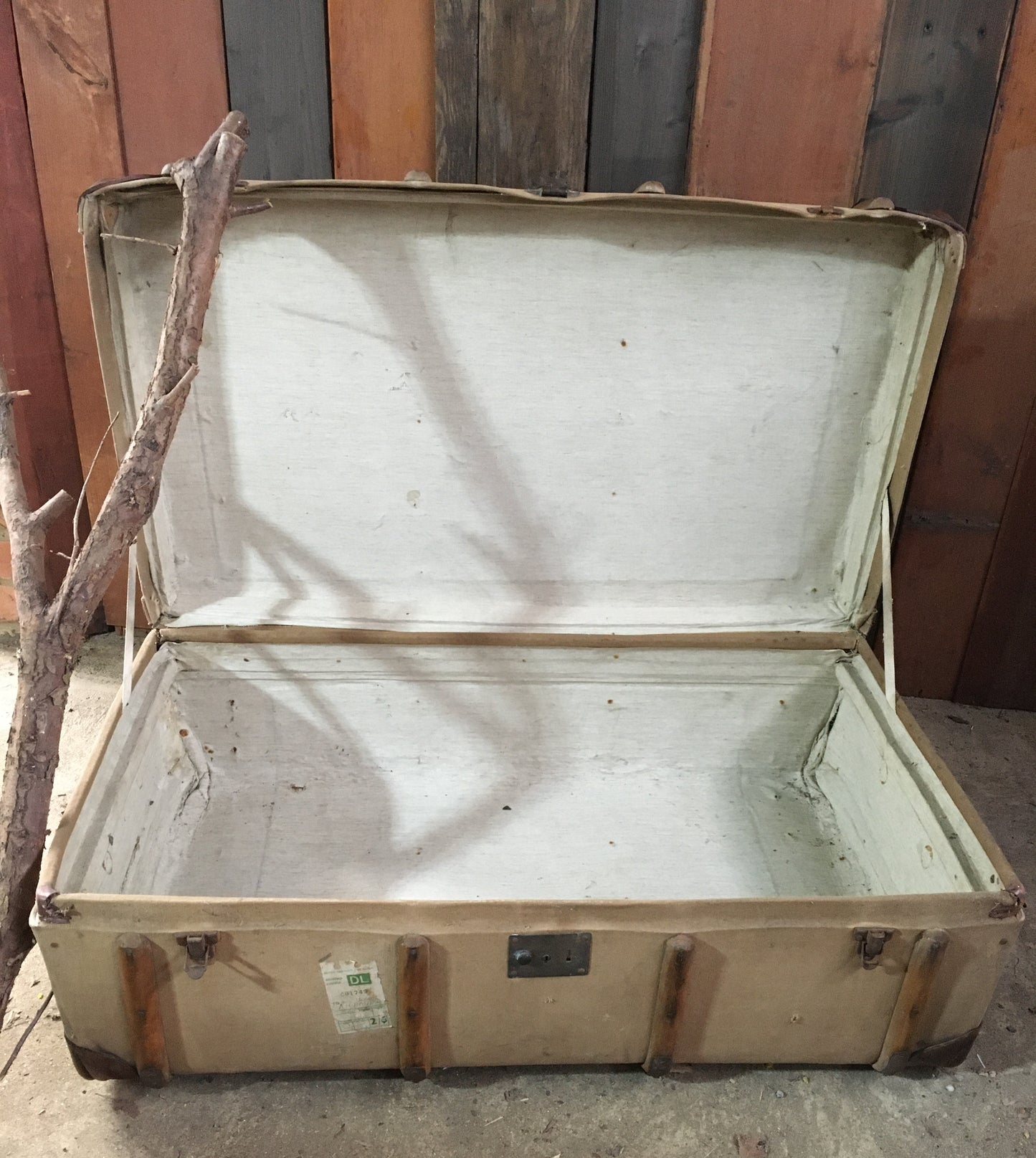 Untouched vintage steamer travel trunk with labels.