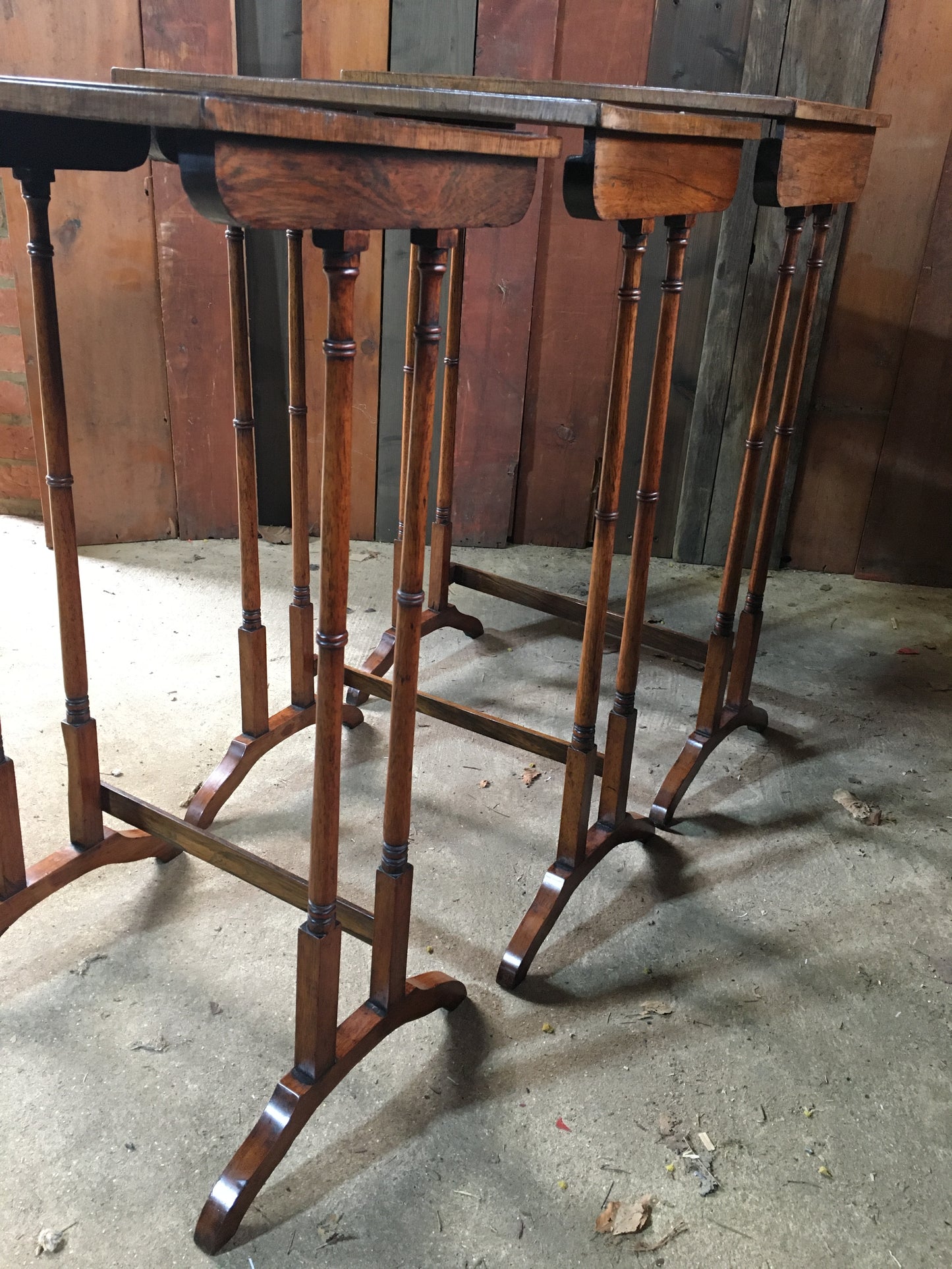 A nest of three late Regency rosewood tables.