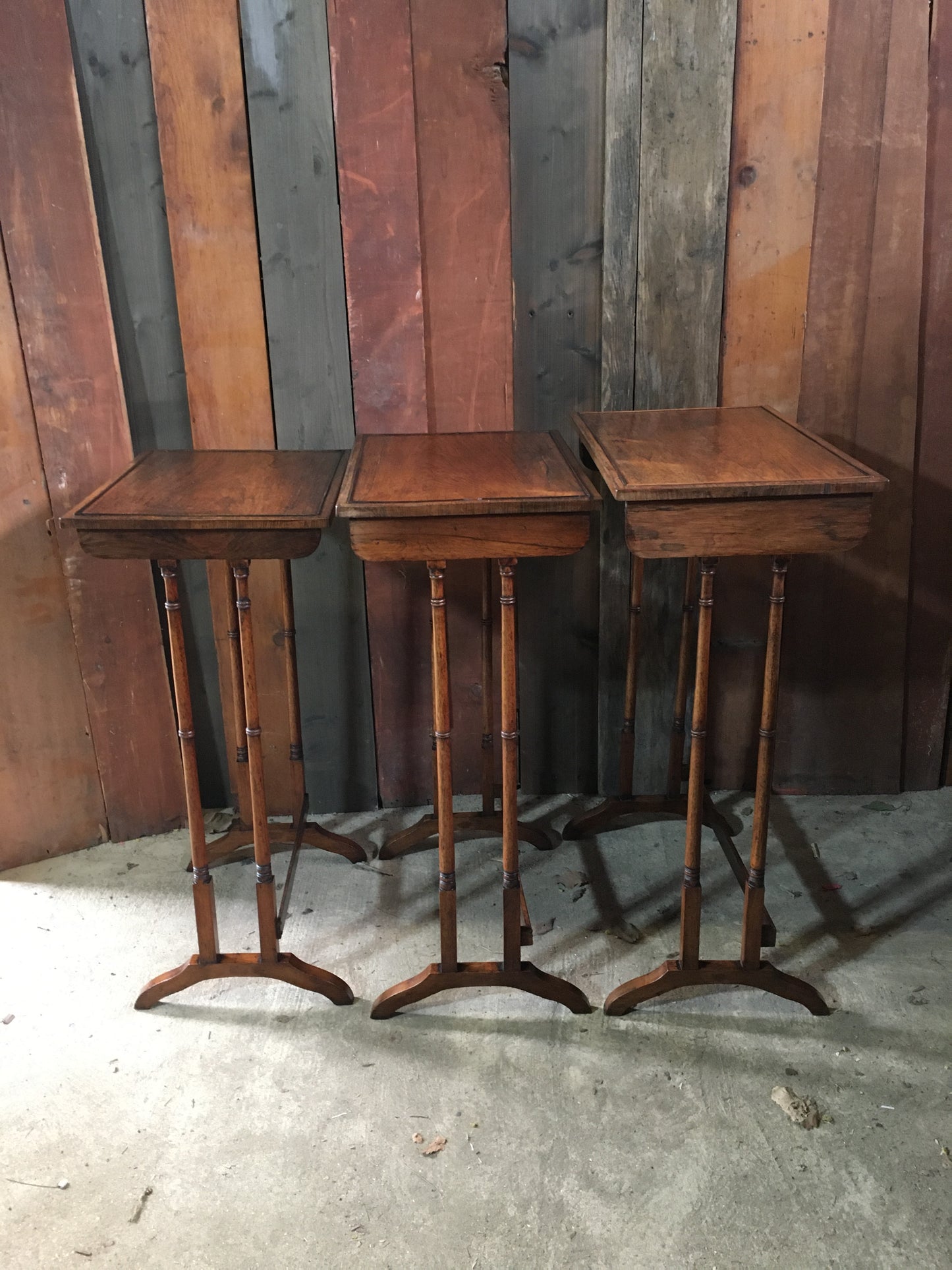 A nest of three late Regency rosewood tables.