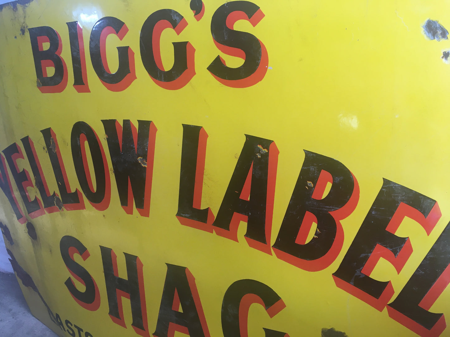Large vintage enamel sign for "Bigg's Yellow Label Shag".