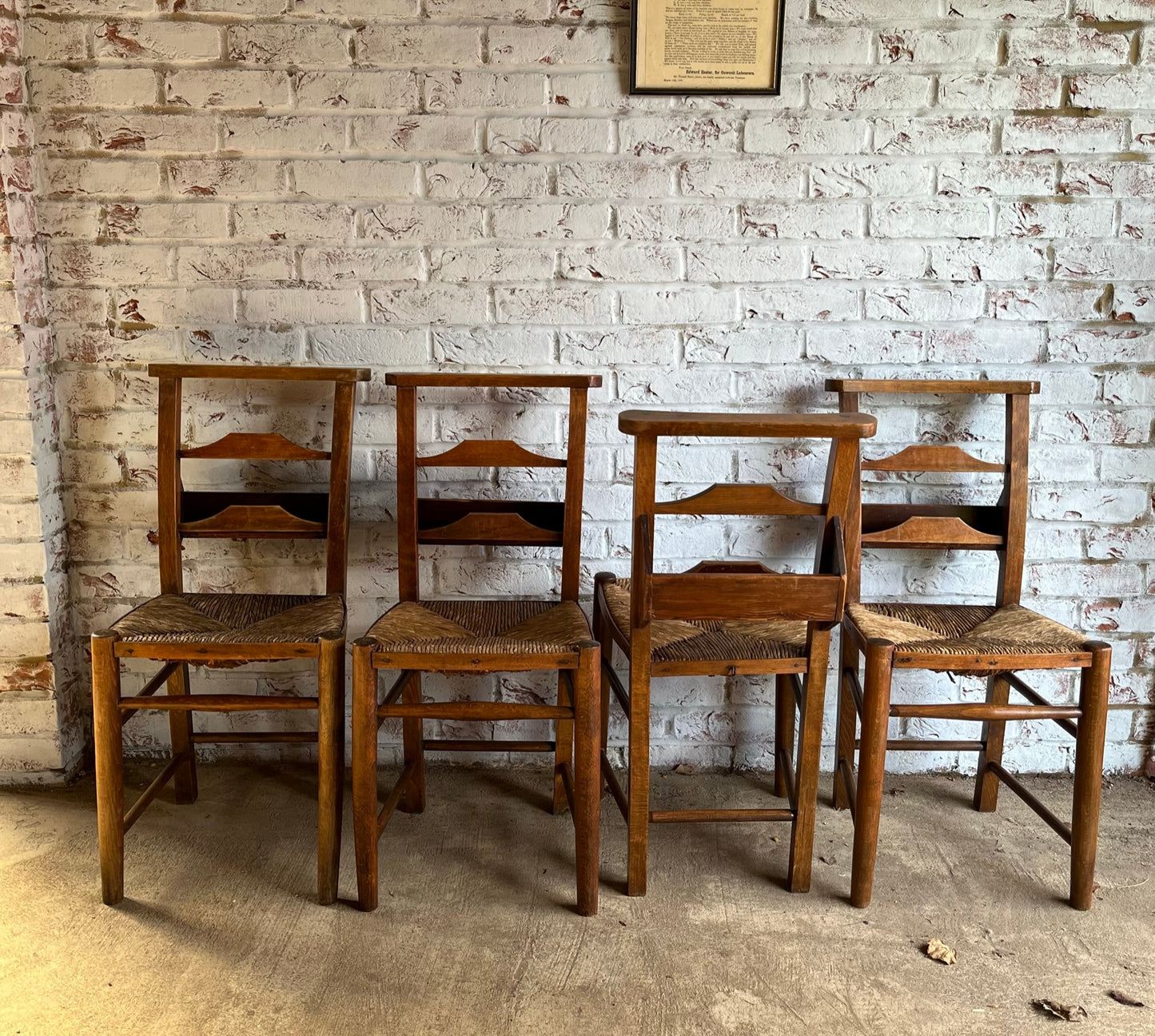 Set of four rustic early 20th century ladder back chapel chairs.