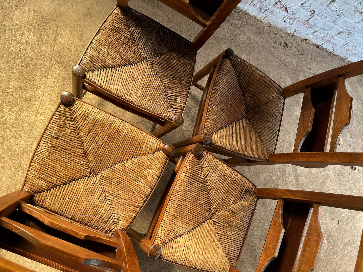 Set of four rustic early 20th century ladder back chapel chairs.