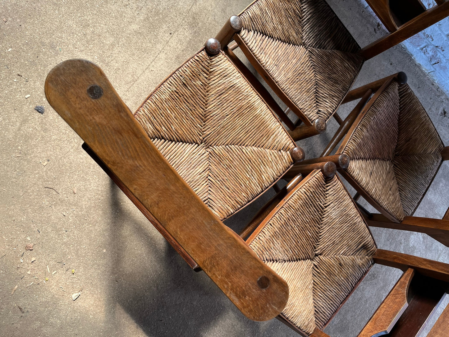 Set of four rustic early 20th century ladder back chapel chairs.