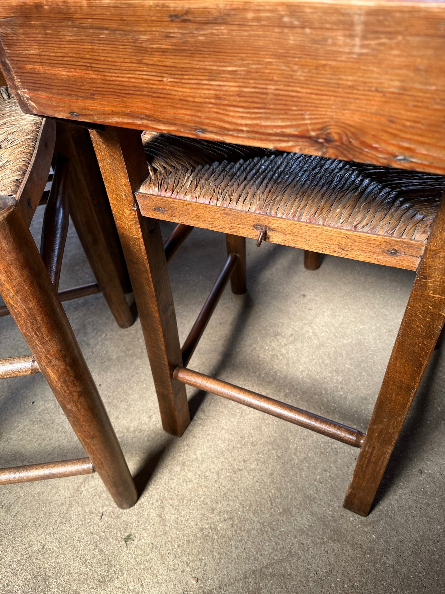 Set of four rustic early 20th century ladder back chapel chairs.
