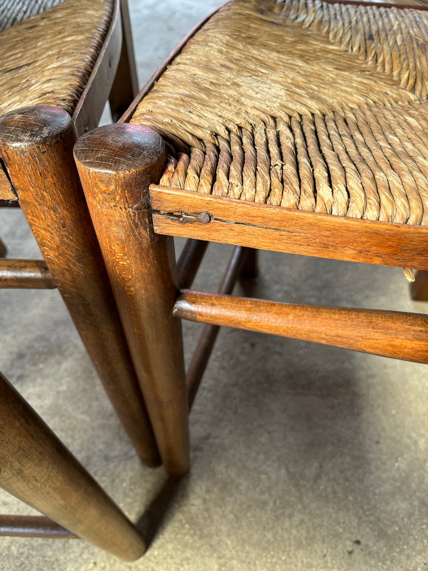 Set of four rustic early 20th century ladder back chapel chairs.