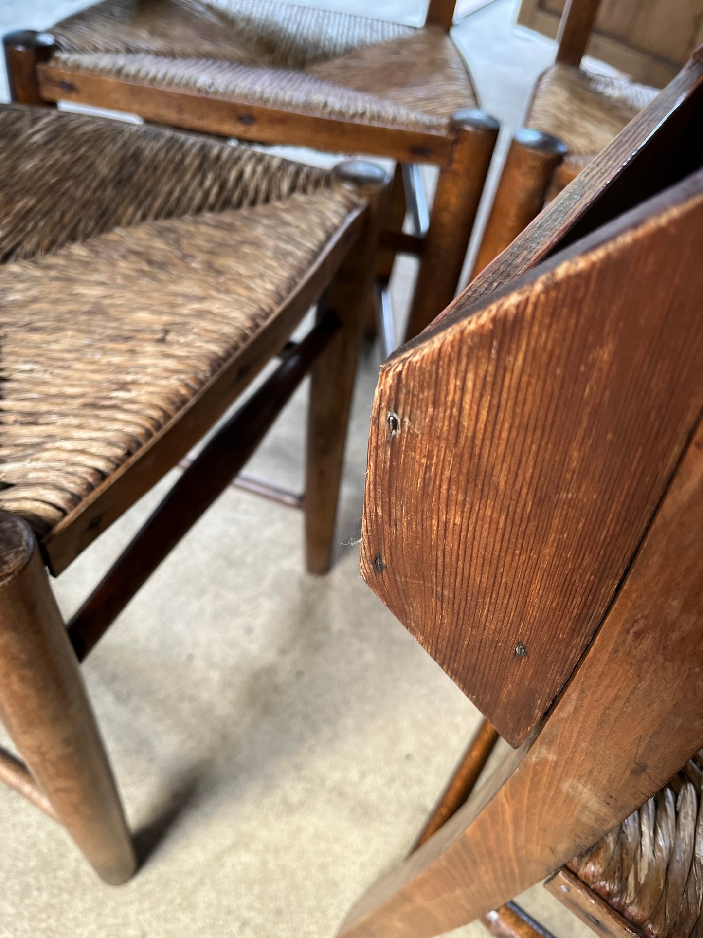 Set of four rustic early 20th century ladder back chapel chairs.
