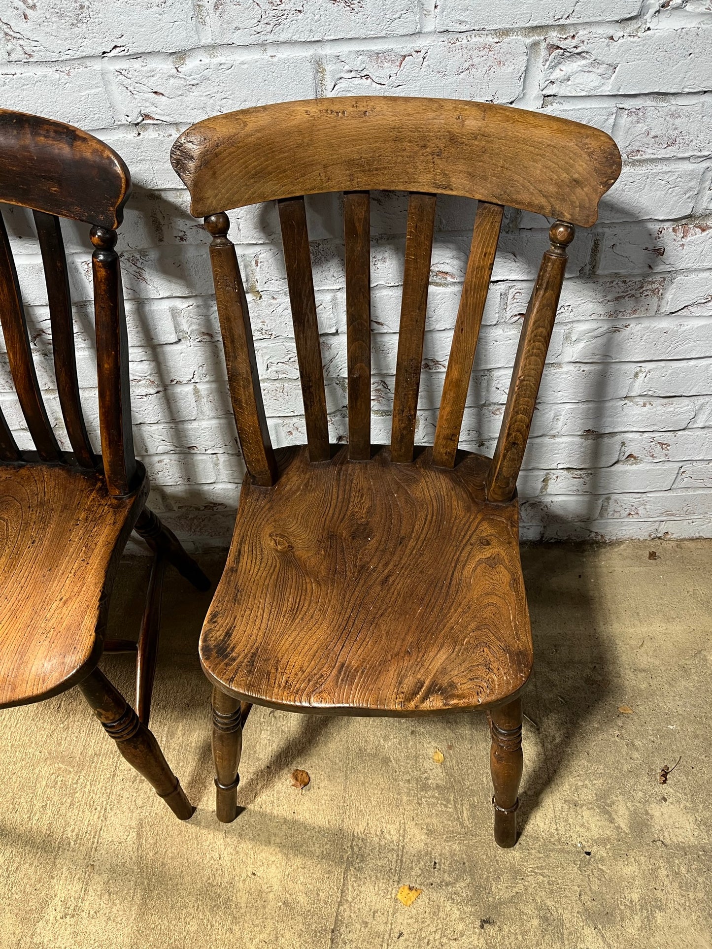 Near pair of Victorian elm slat back Windsor kitchen chairs.
