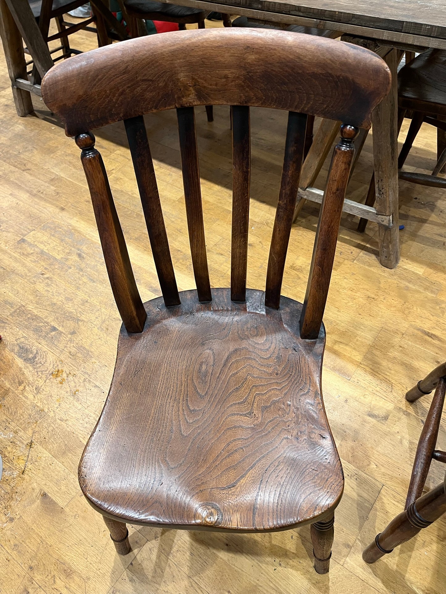 A pair of elm Windsor slat back country kitchen chairs.