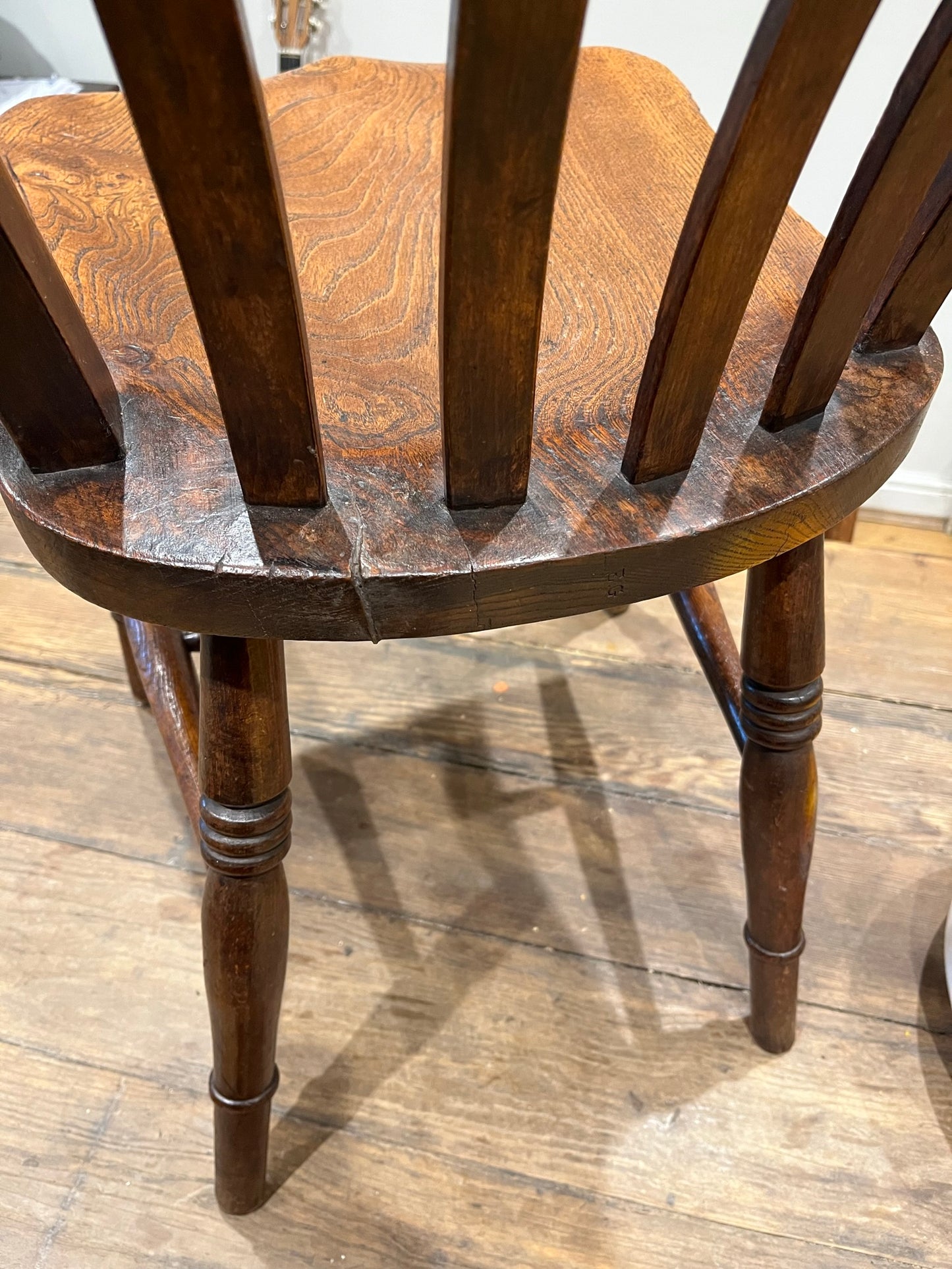 A pair of elm Windsor slat back country kitchen chairs.