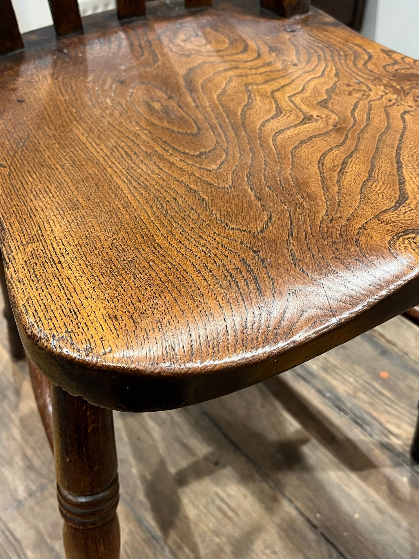 A pair of elm Windsor slat back country kitchen chairs.