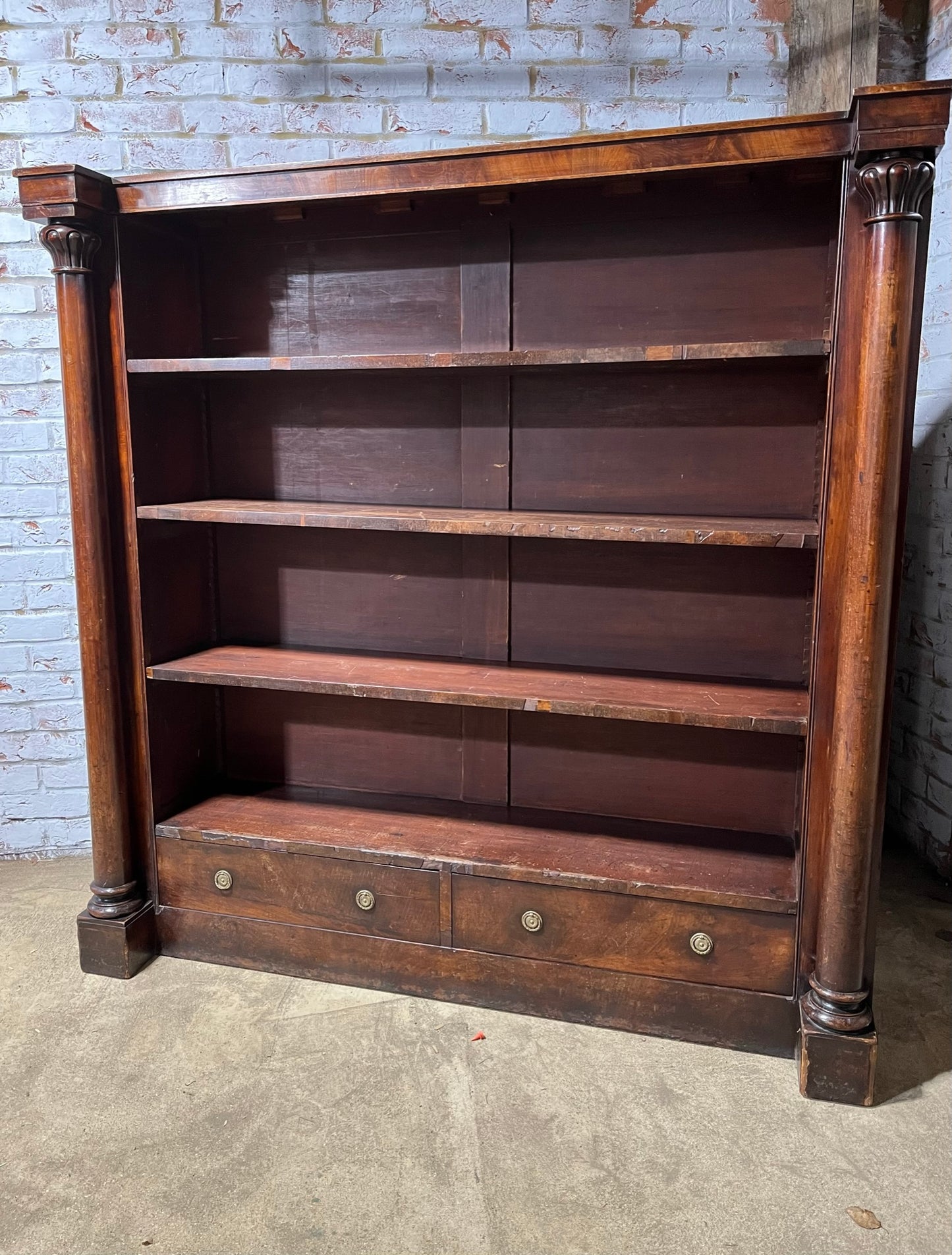 A very large William IV/early Victorian mahogany open bookcase with drawers.