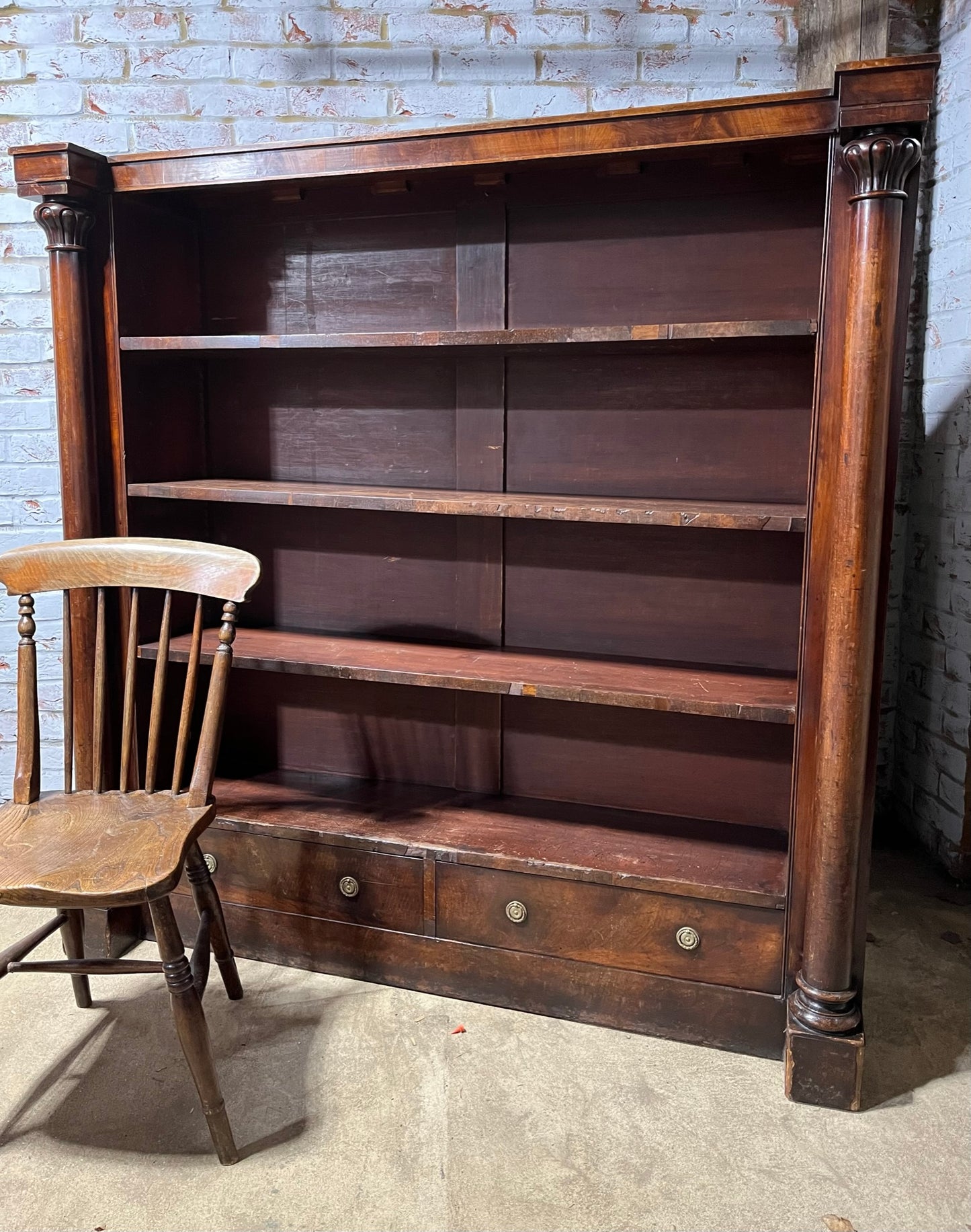 A very large William IV/early Victorian mahogany open bookcase with drawers.