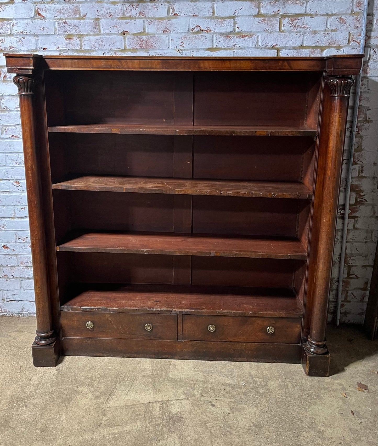 A very large William IV/early Victorian mahogany open bookcase with drawers.