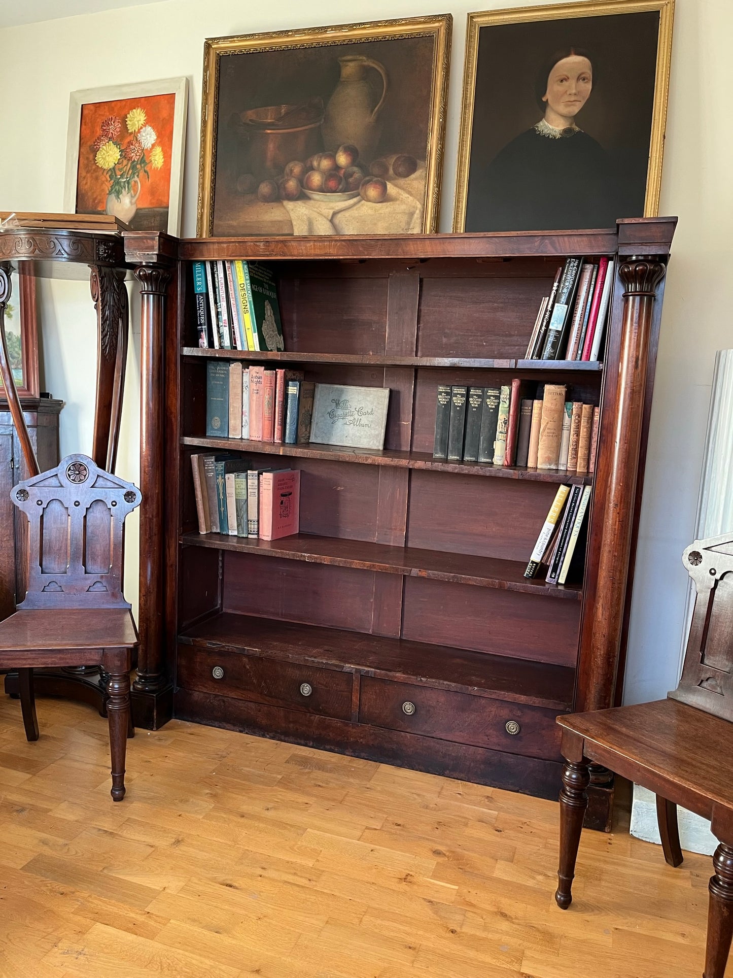A very large William IV/early Victorian mahogany open bookcase with drawers.