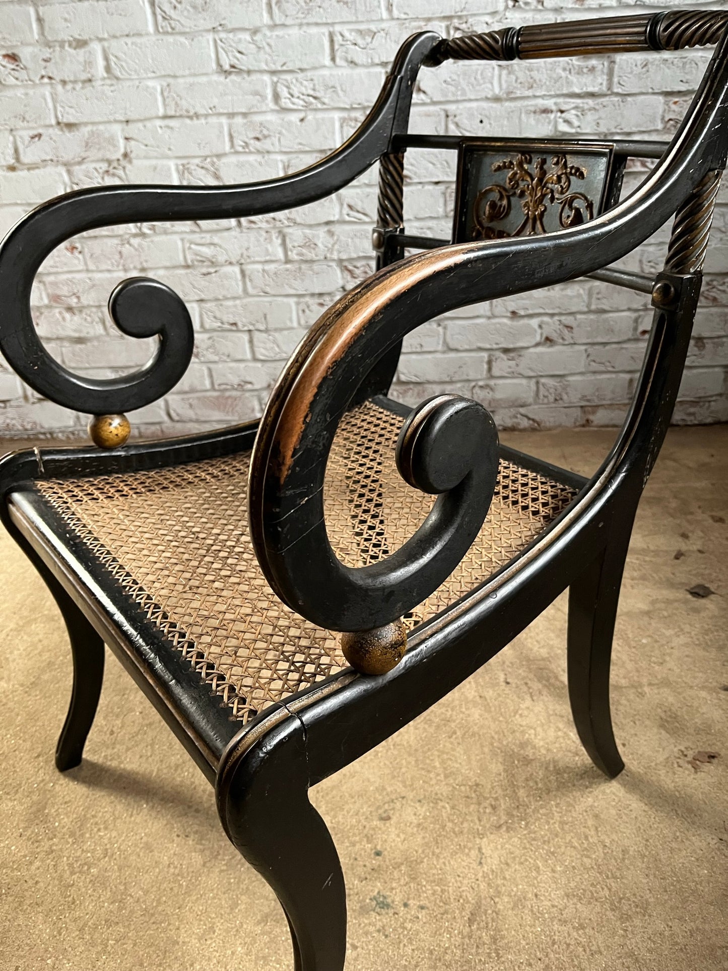 Regency ebonised and painted armchair.