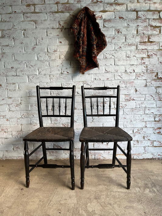 19th century pair of ebonised spindle back chairs.