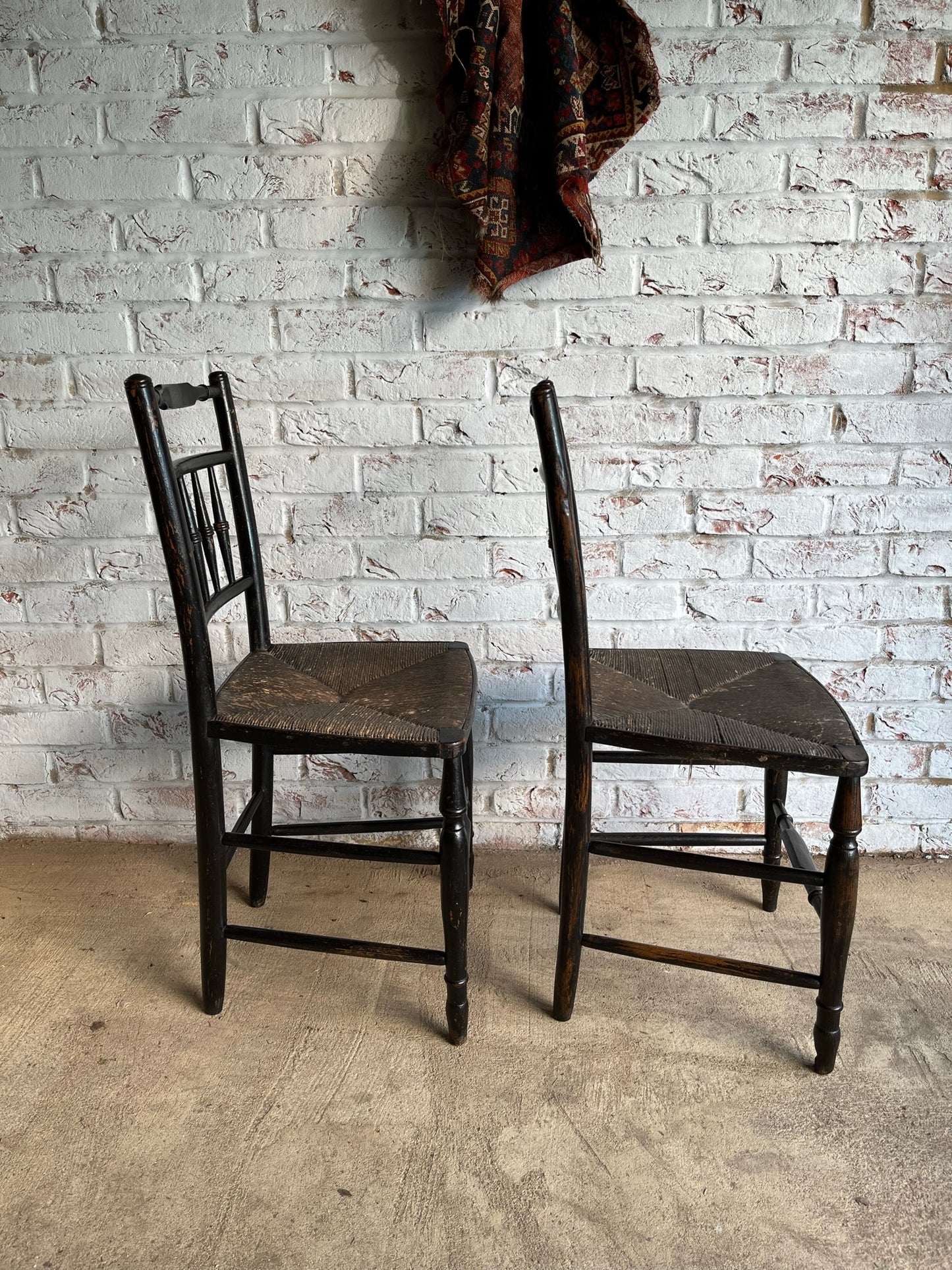 19th century pair of ebonised spindle back chairs.