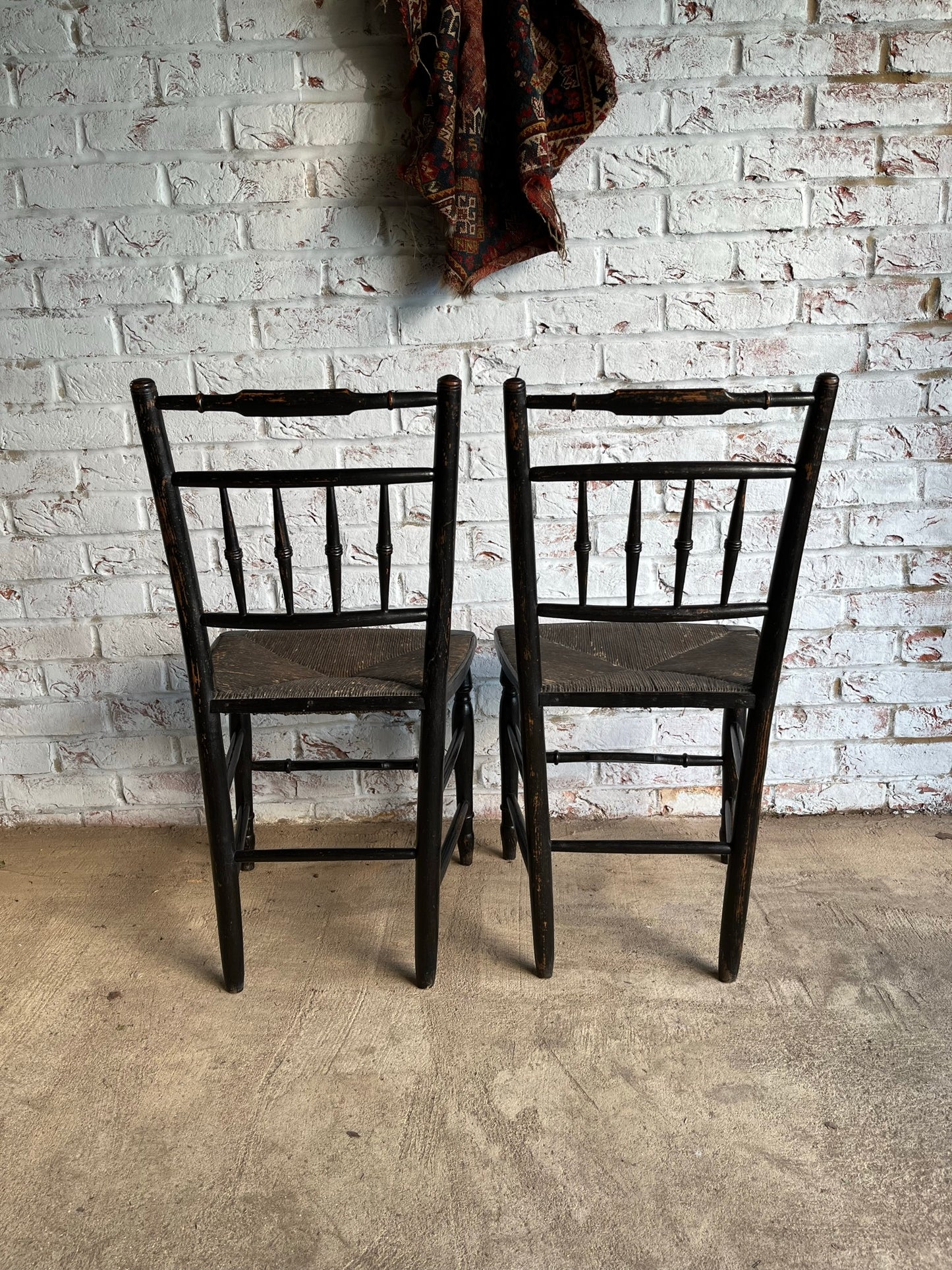 19th century pair of ebonised spindle back chairs.