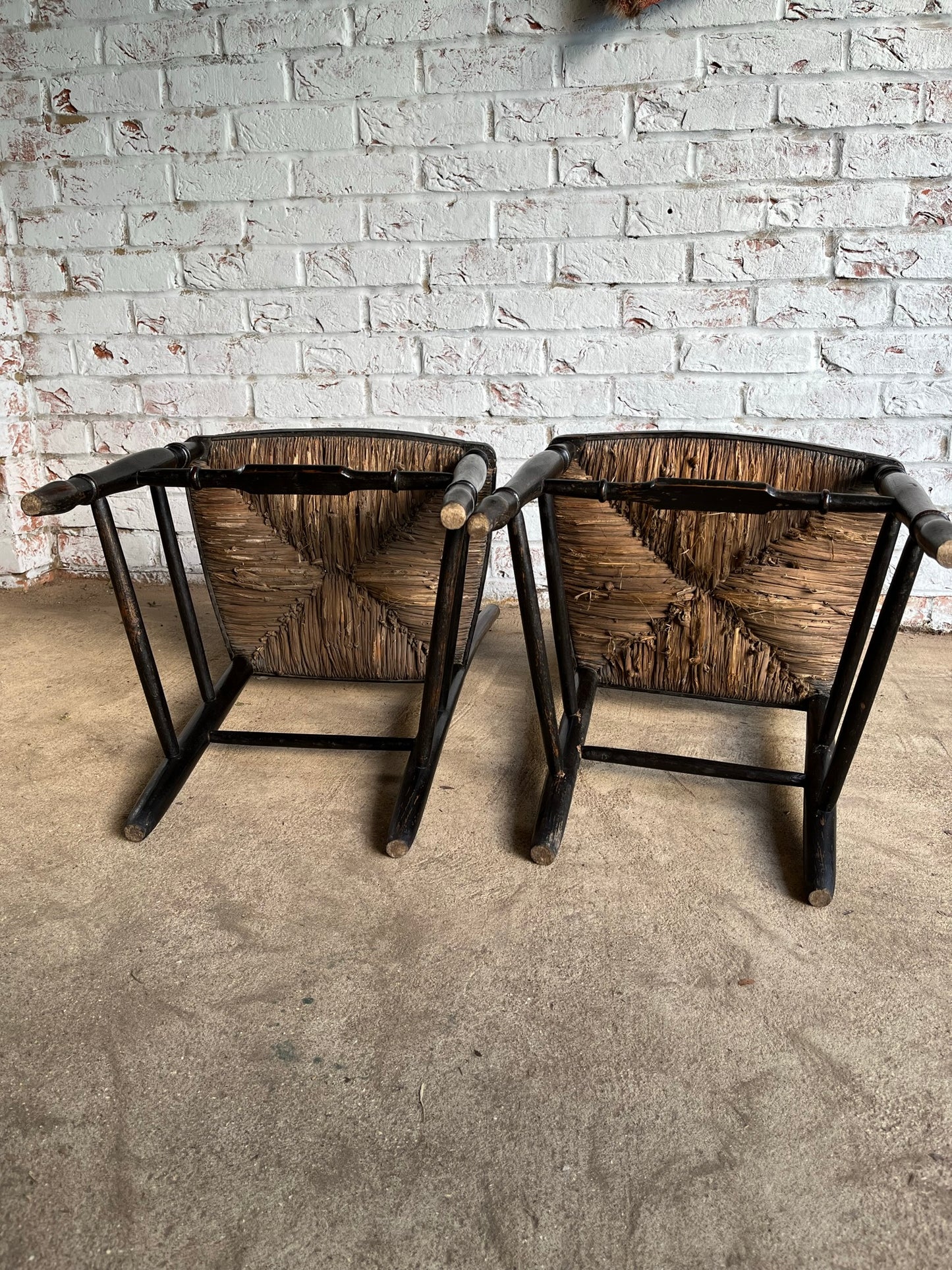 19th century pair of ebonised spindle back chairs.