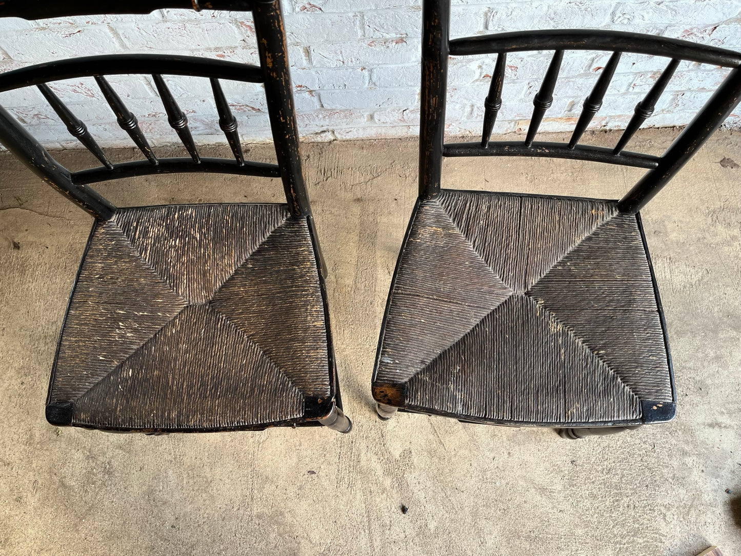 19th century pair of ebonised spindle back chairs.