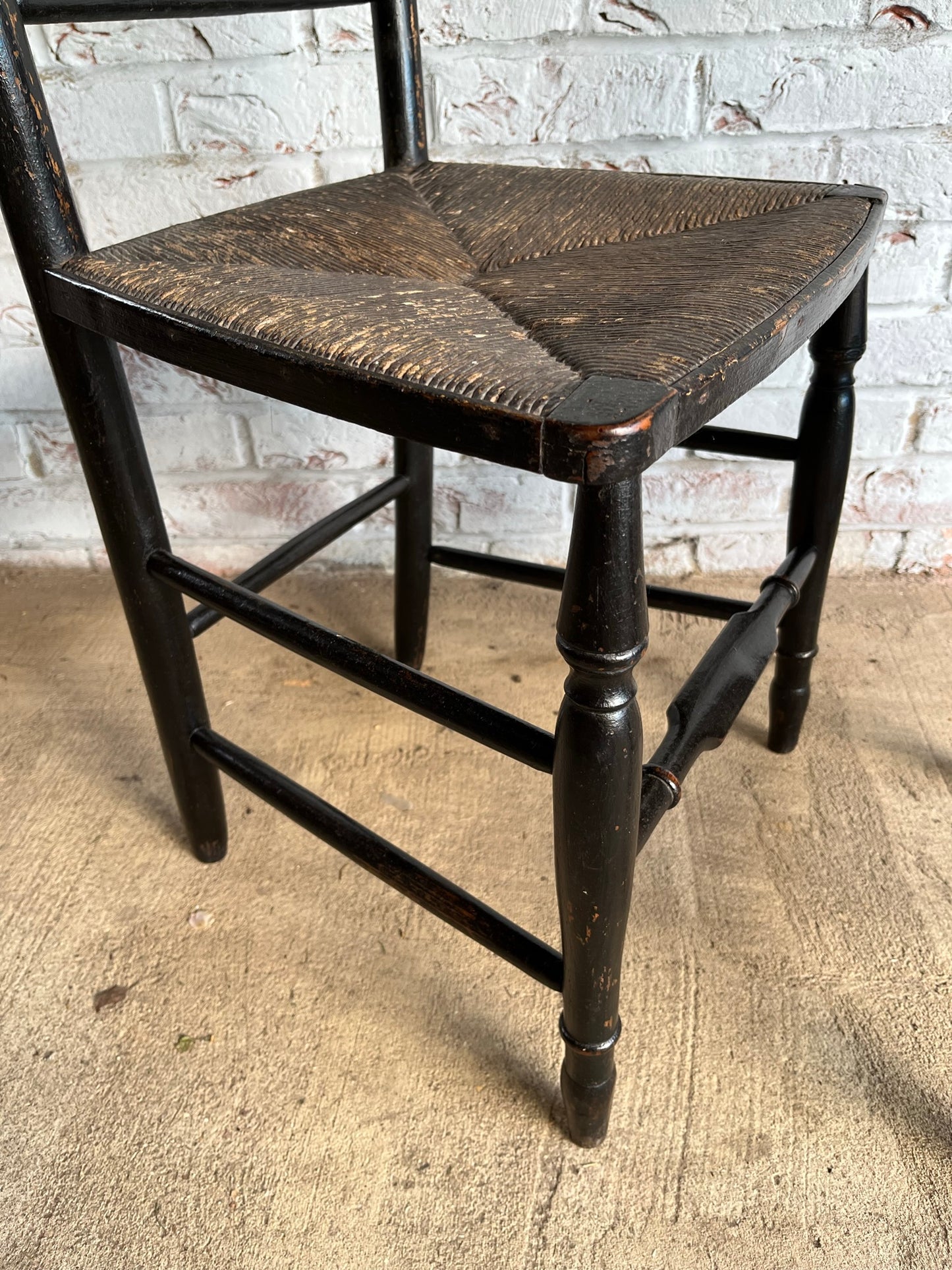 19th century pair of ebonised spindle back chairs.