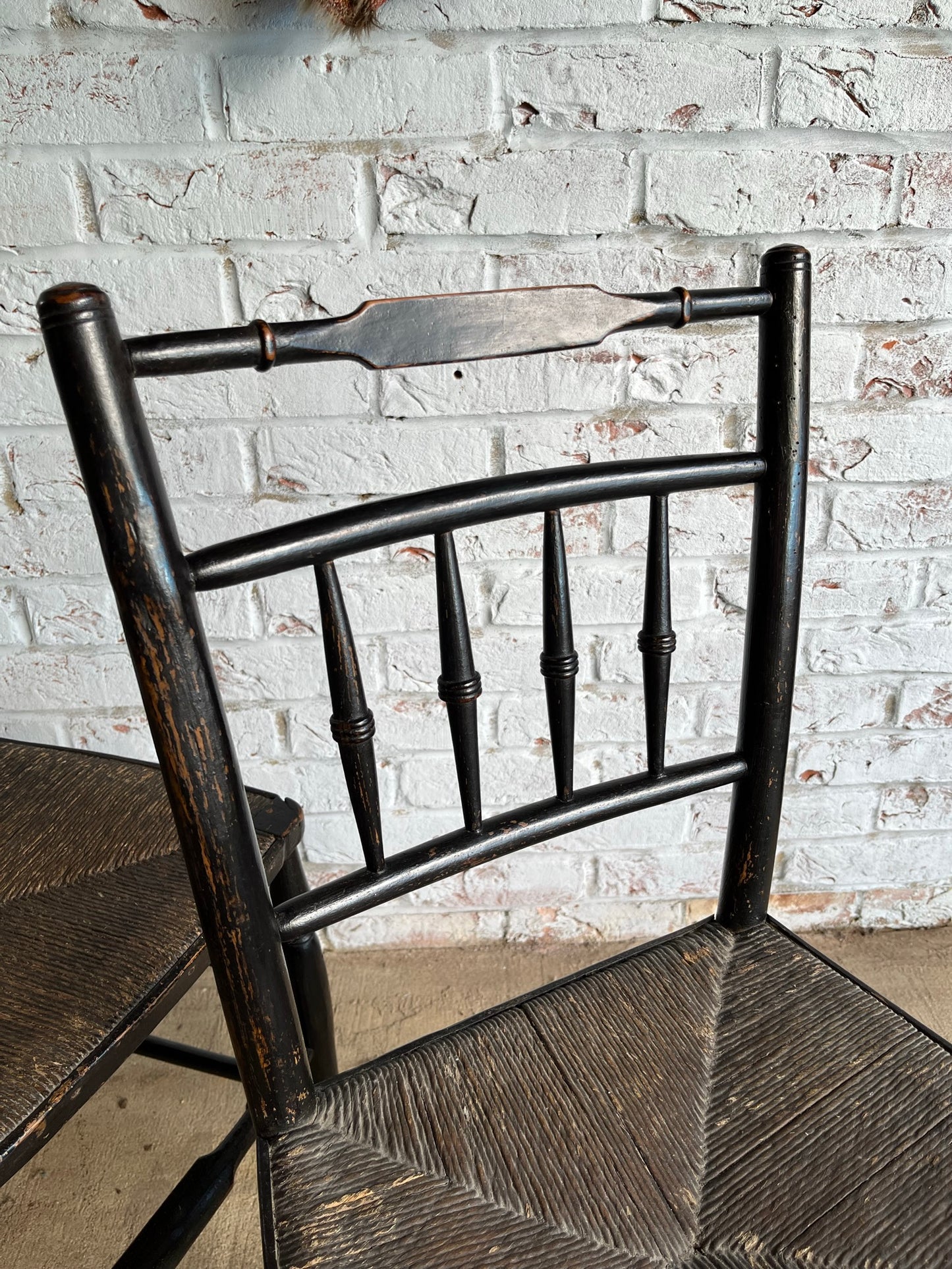 19th century pair of ebonised spindle back chairs.