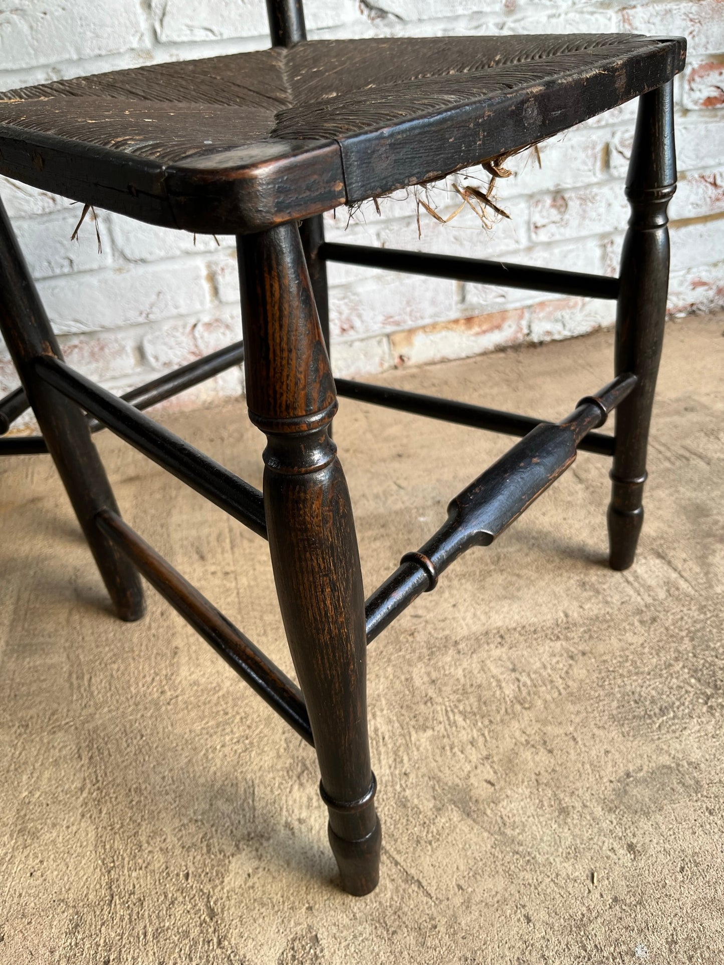 19th century pair of ebonised spindle back chairs.