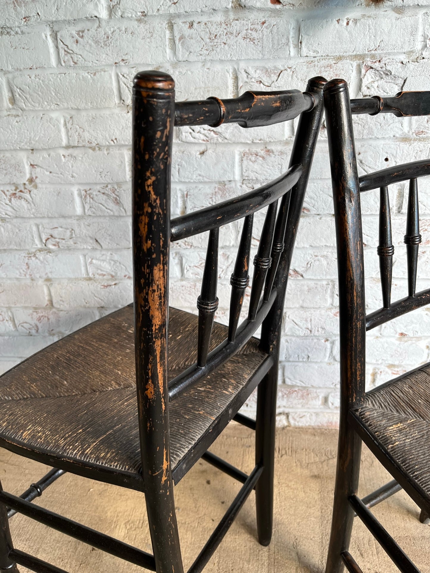 19th century pair of ebonised spindle back chairs.