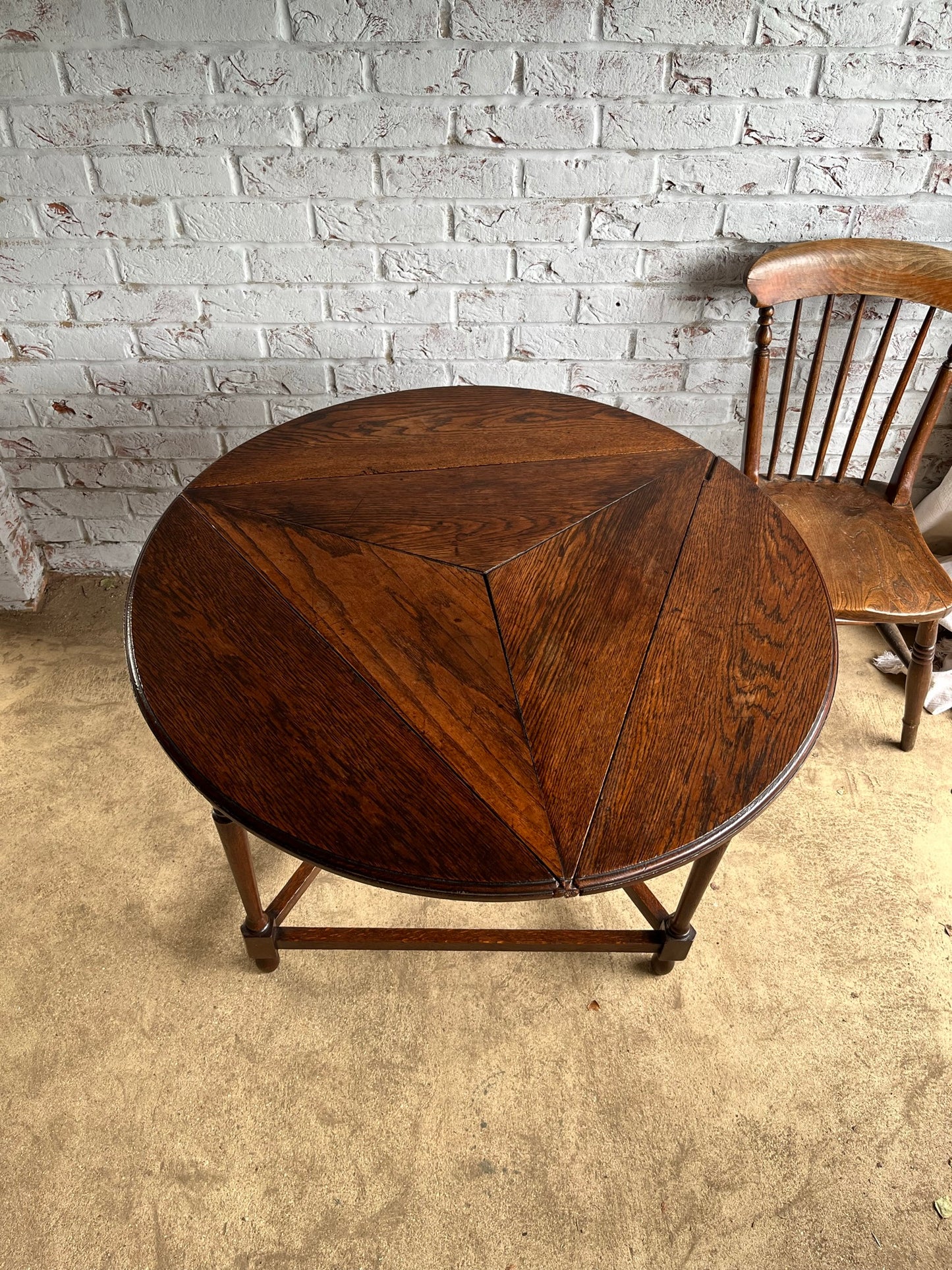 Late 19th/early 20th century oak cricket table with drop flap top.