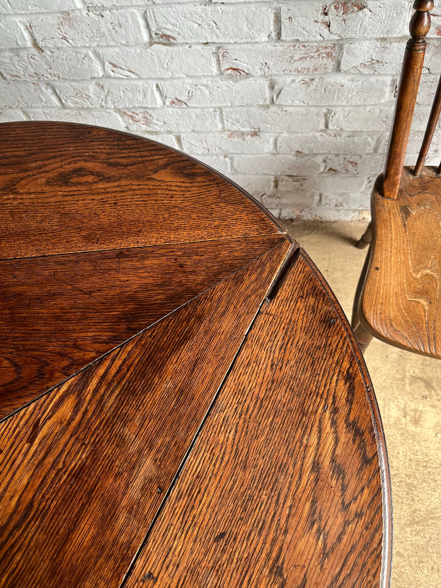 Late 19th/early 20th century oak cricket table with drop flap top.
