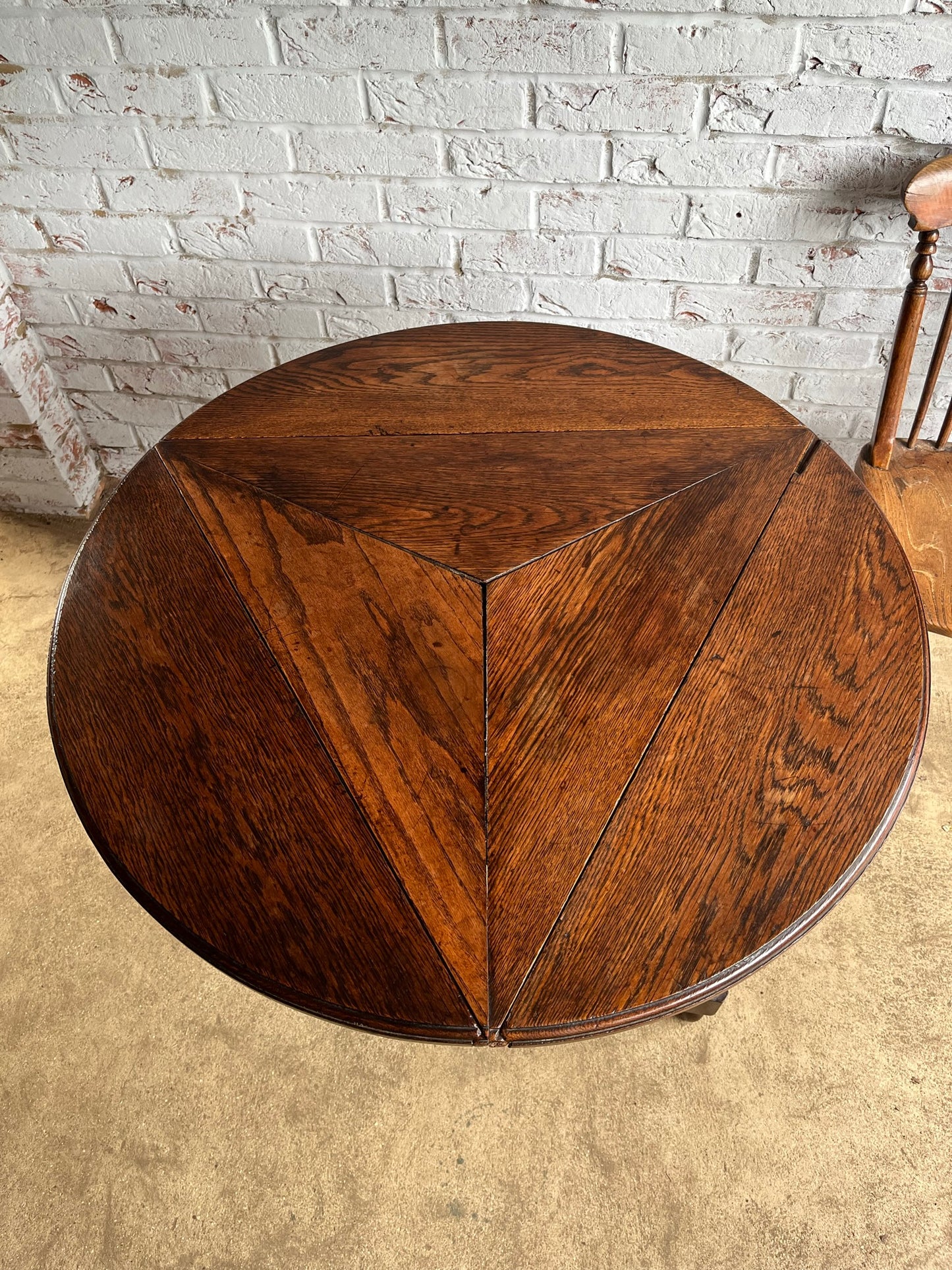 Late 19th/early 20th century oak cricket table with drop flap top.
