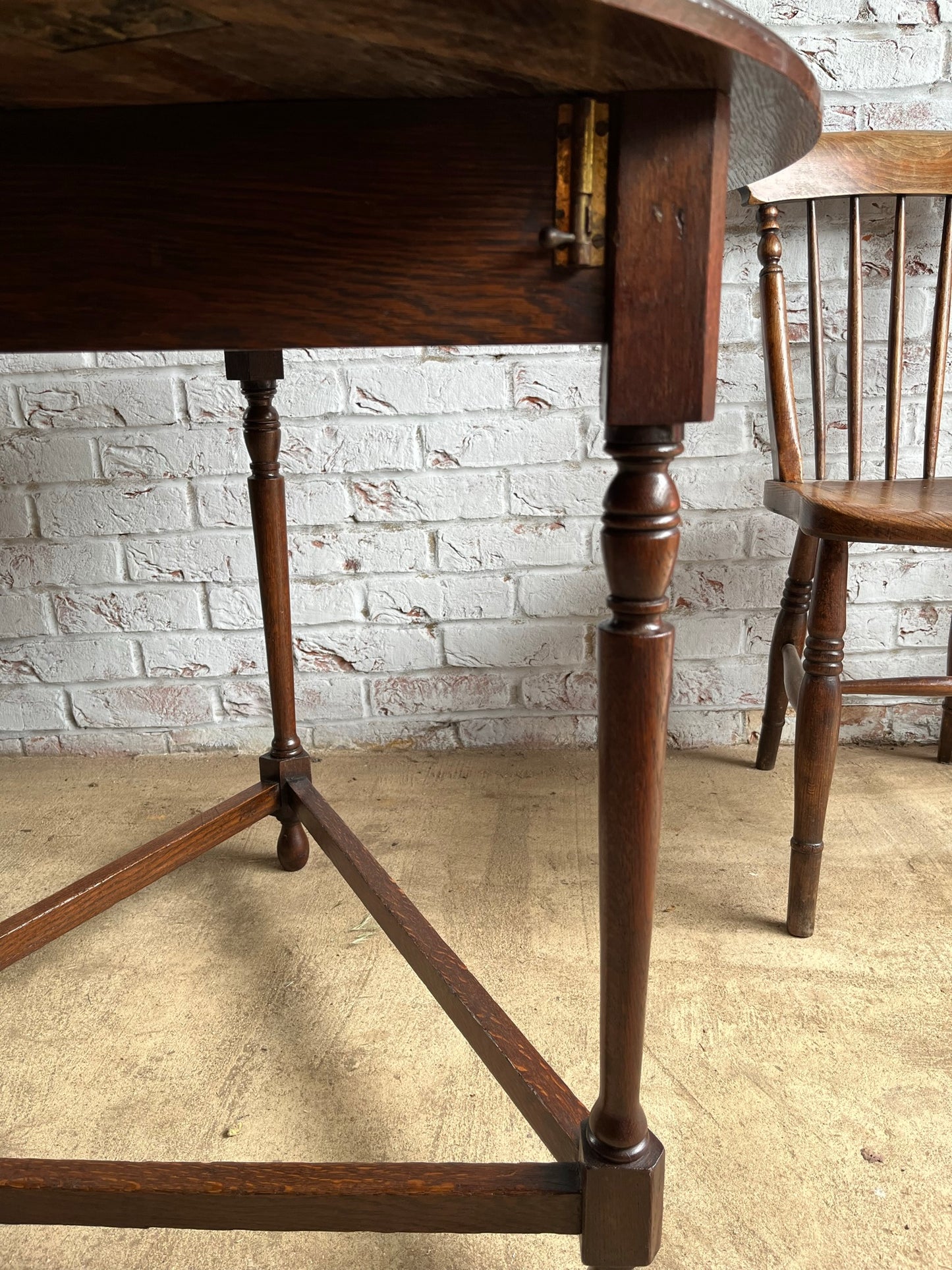 Late 19th/early 20th century oak cricket table with drop flap top.