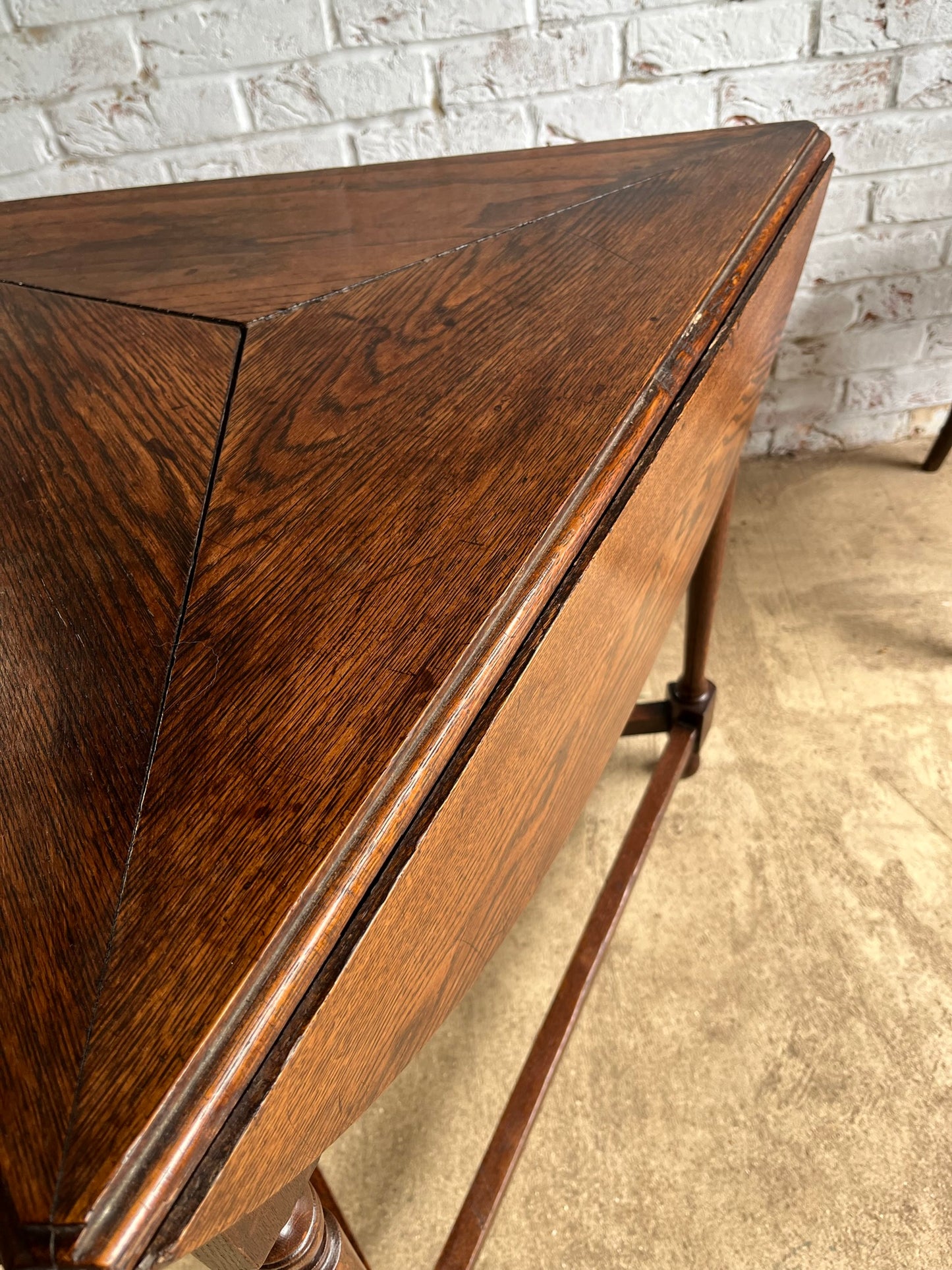 Late 19th/early 20th century oak cricket table with drop flap top.