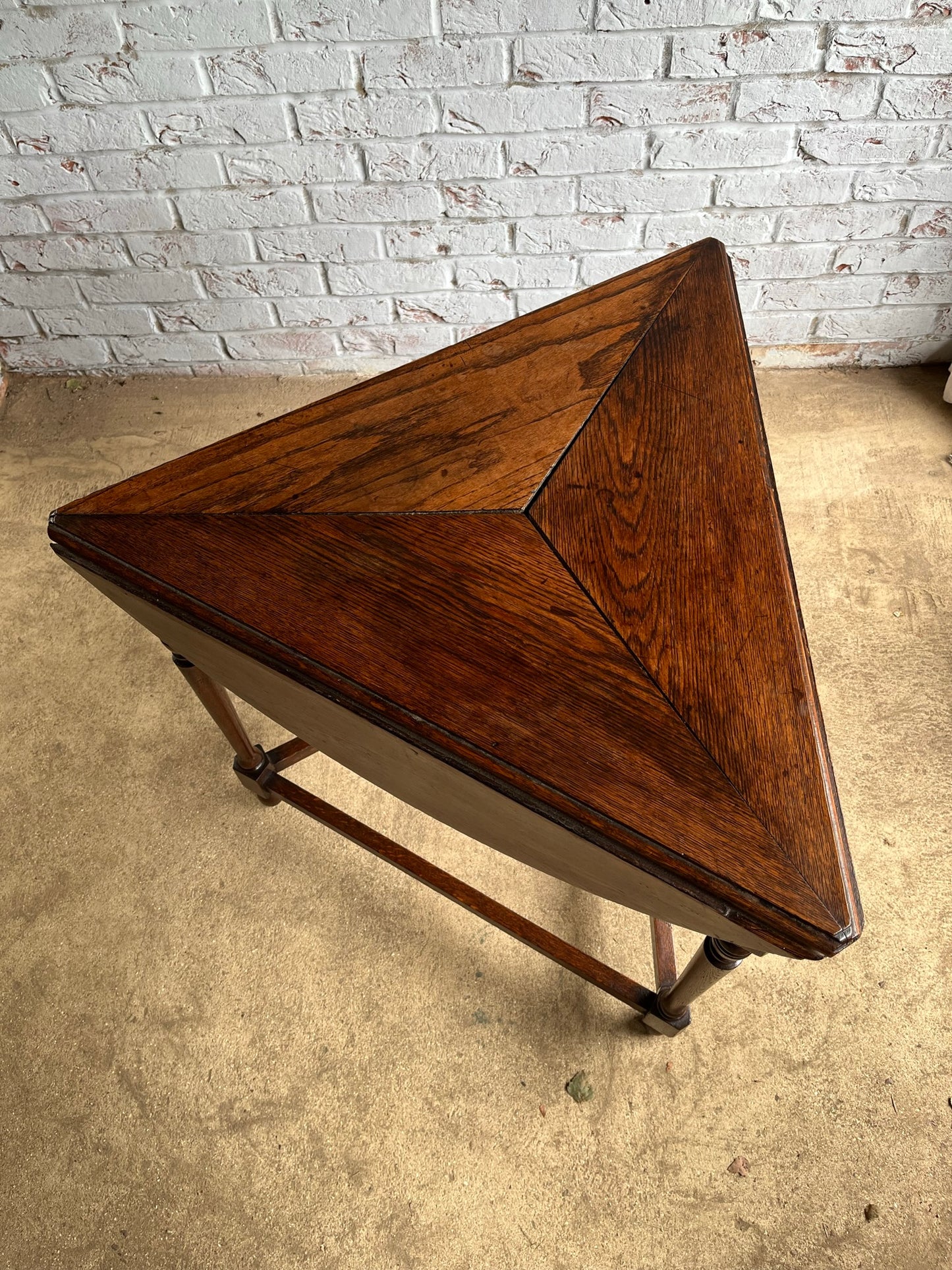 Late 19th/early 20th century oak cricket table with drop flap top.