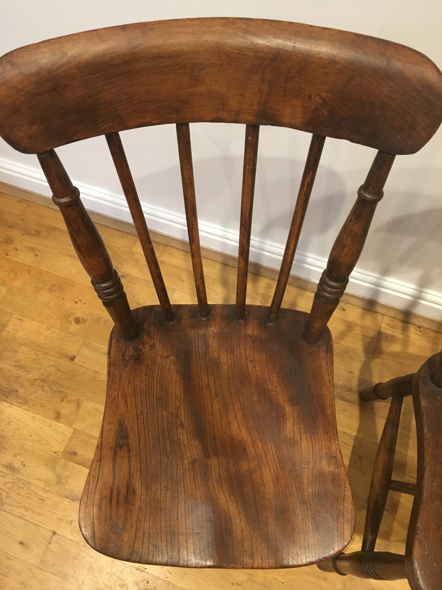 A pair of Victorian spindle-back kitchen chairs.