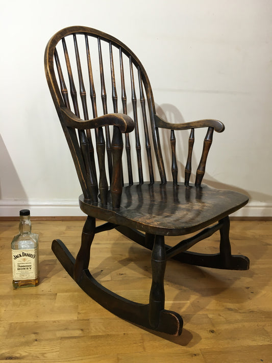 Charming low rocking chair with faux bamboo spindles.