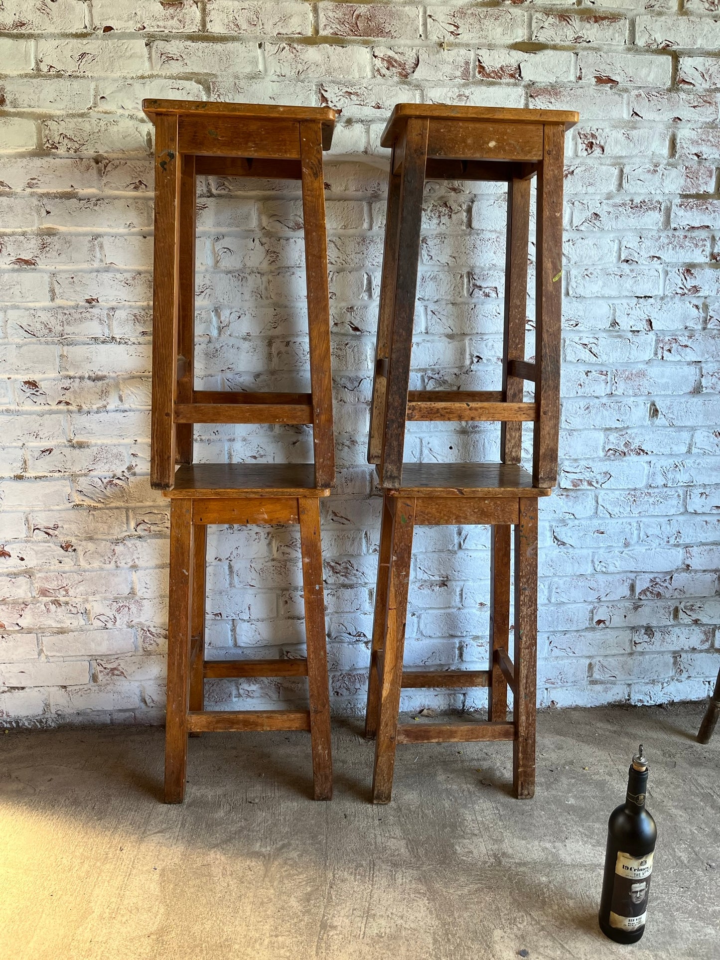 Set of four tall vintage oak school/lab/factory stools with old paint.