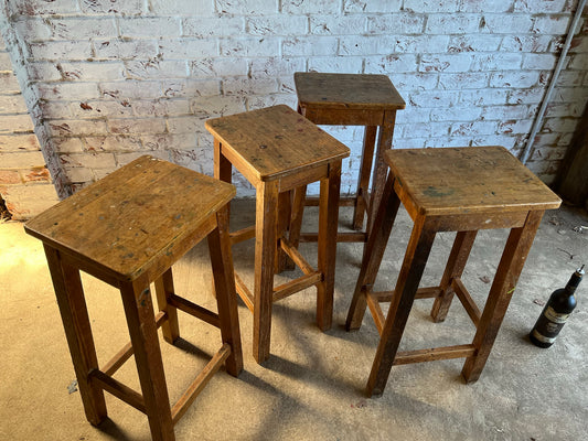 Set of four tall vintage oak school/lab/factory stools with old paint.