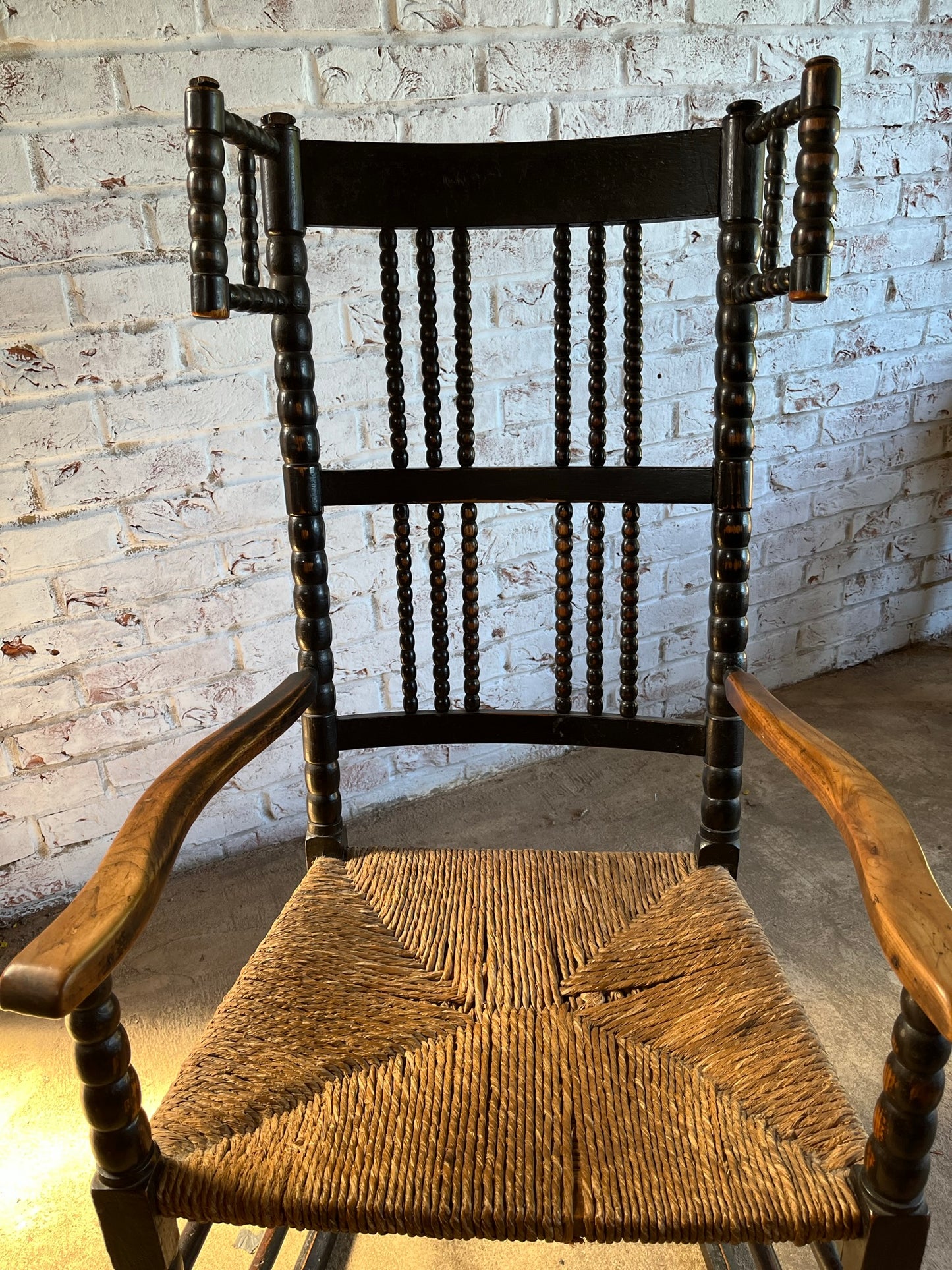 Arts and Crafts bobbin-turned rocking chair, in the style of Ernest Gimson, circa 1900-1910.