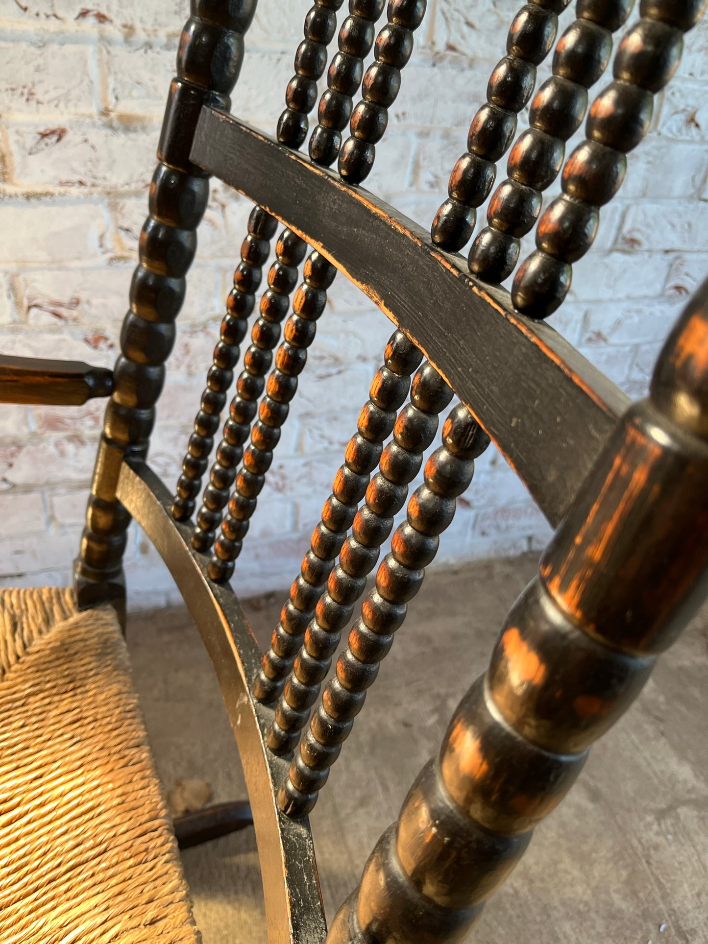 Arts and Crafts bobbin-turned rocking chair, in the style of Ernest Gimson, circa 1900-1910.