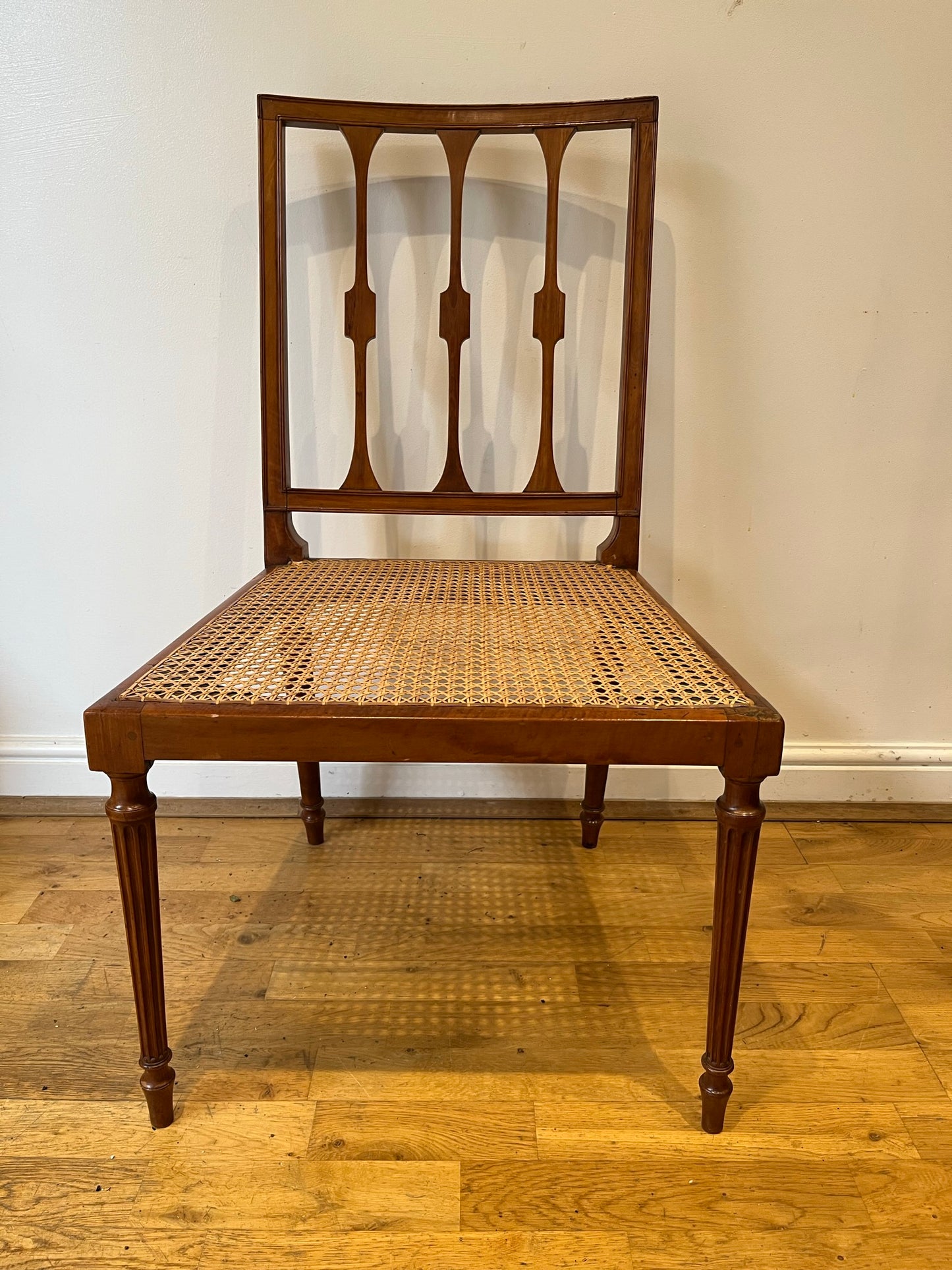 Fine cane-seated chair from Brudenell House, Bucks, in the manner of Gillows.